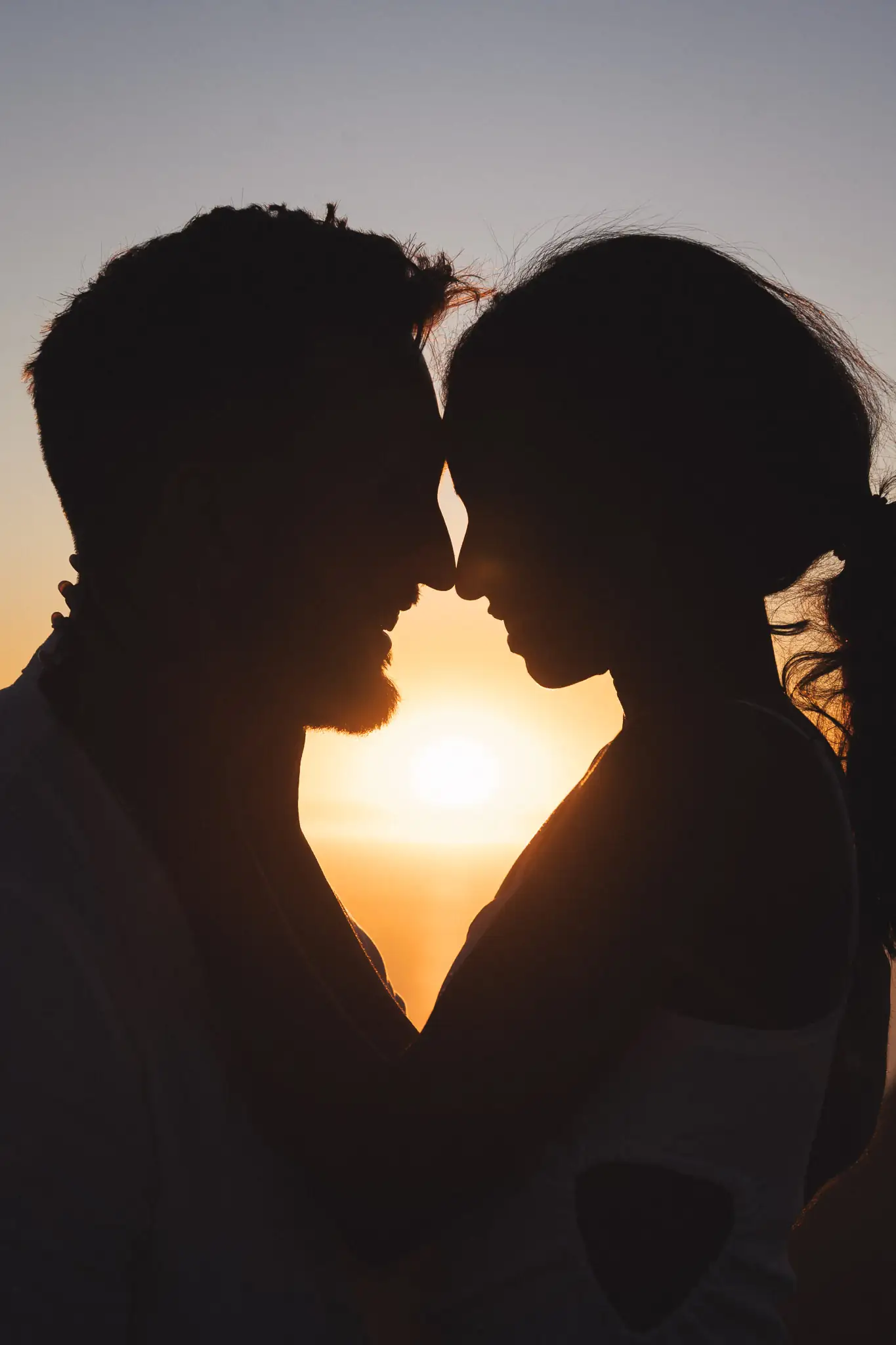 Couple silhouetted forehead-to-forehead at sunset — couple photographer Cape Town