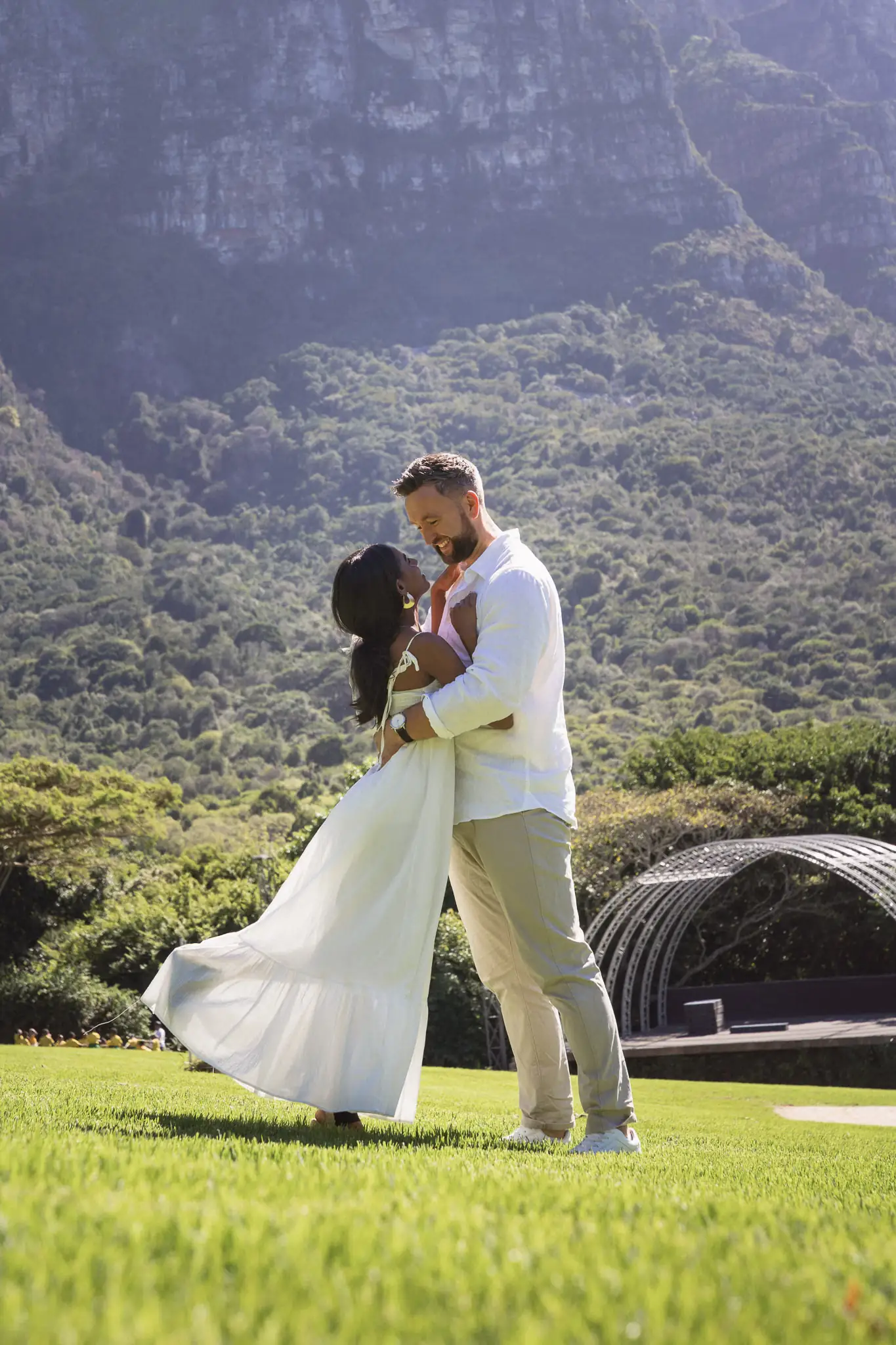Couple dancing in a garden with mountains behind — couple photographer Cape Town