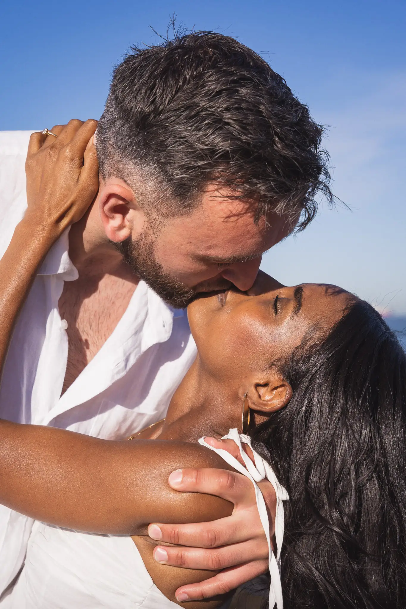 Close-up of a couple kissing at sunset, engagement ring visible — engagement photographer Cape Town