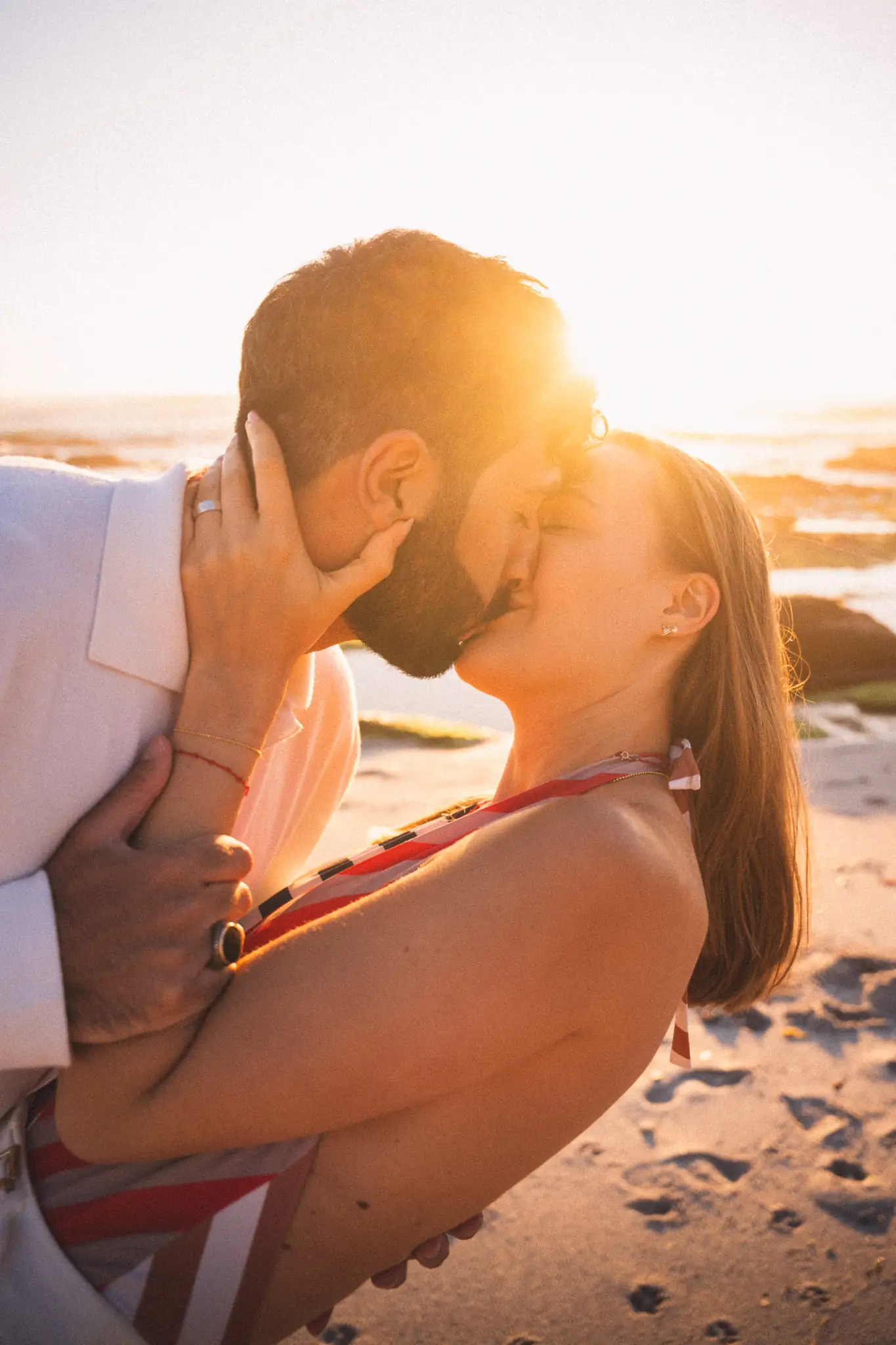 Couple kissing on the beach at golden hour — couple photographer Cape Town