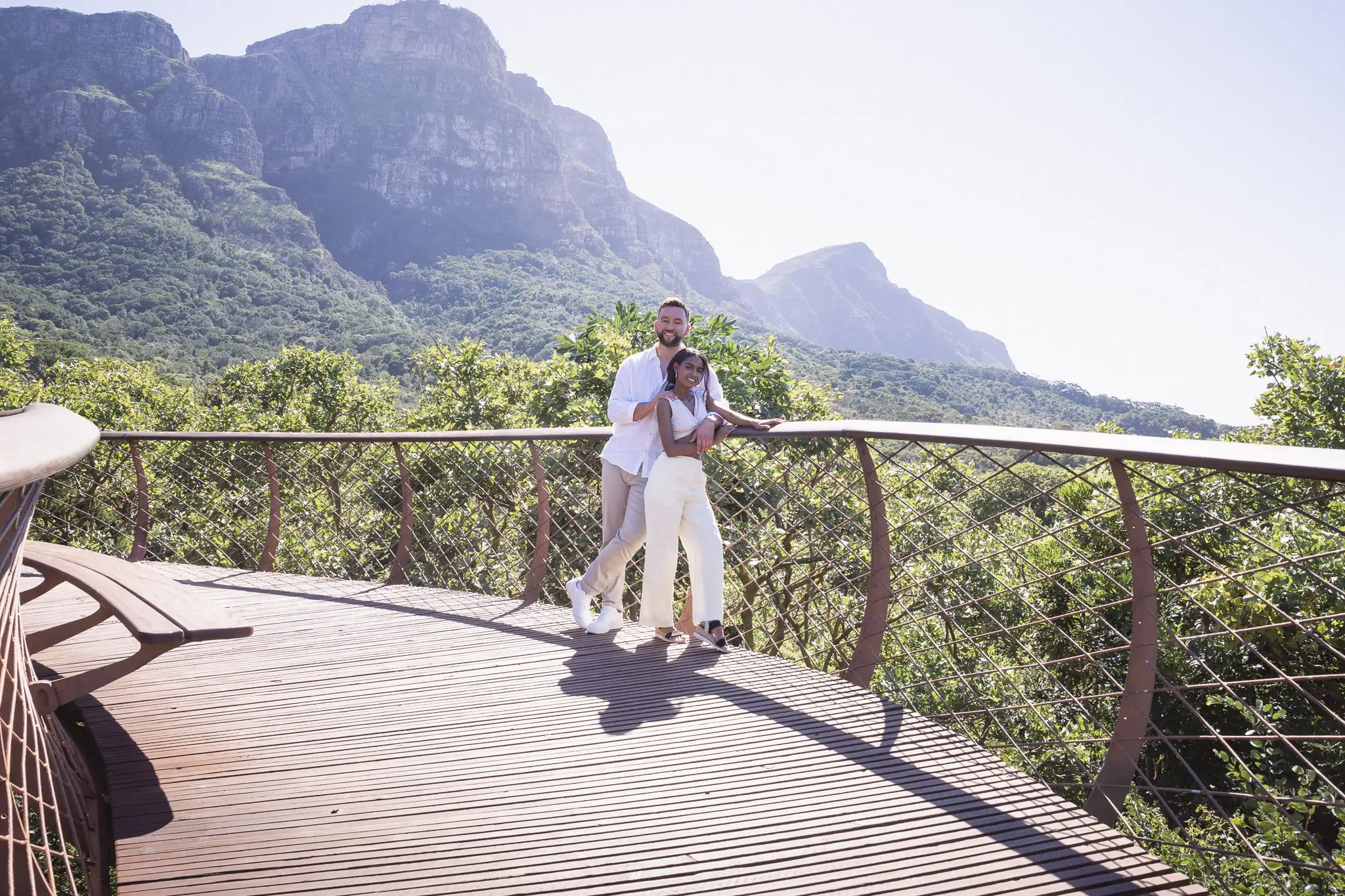 Couple on the Kirstenbosch canopy walkway with mountains behind — couple photographer Cape Town