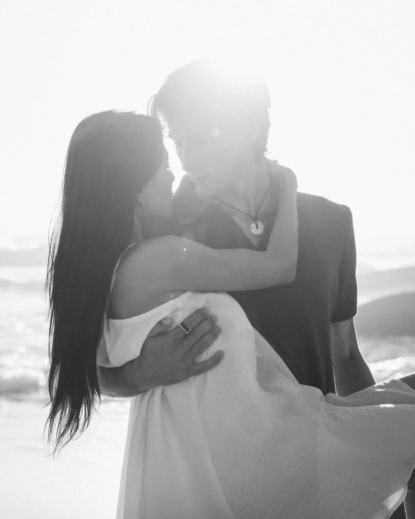 Black-and-white portrait of a couple embracing on the beach — couple photographer Cape Town