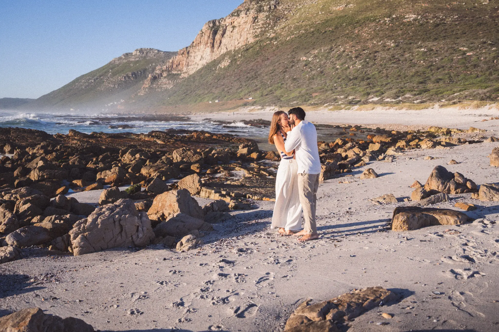 Couple kissing on the rocky coastline at Scarborough — couple photographer Cape Town