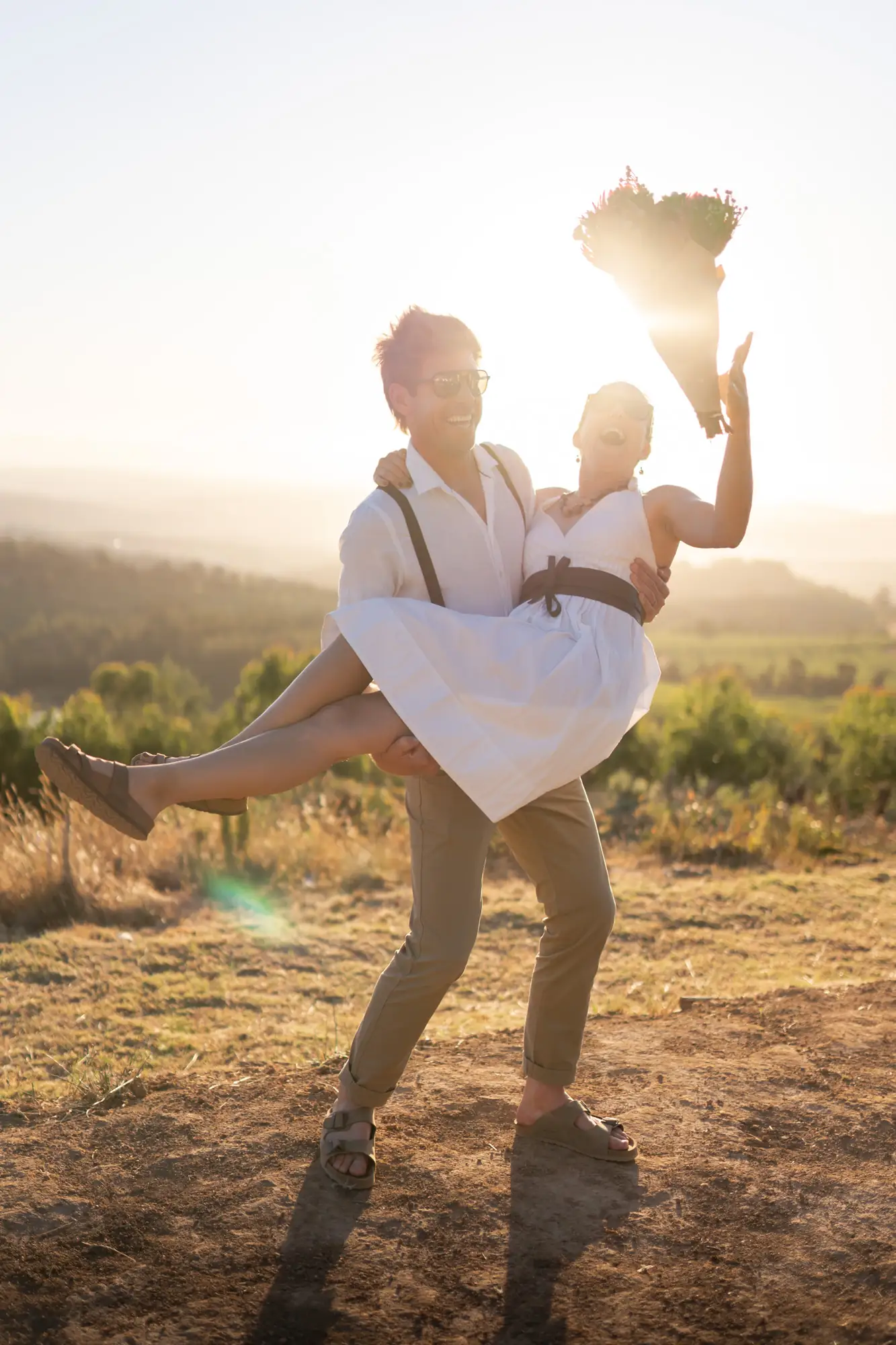 Couple laughing in a Stellenbosch vineyard — couple photographer Cape Town
