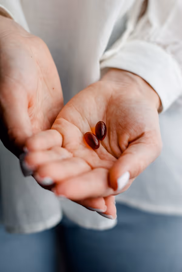 person holding brown and black round ornament