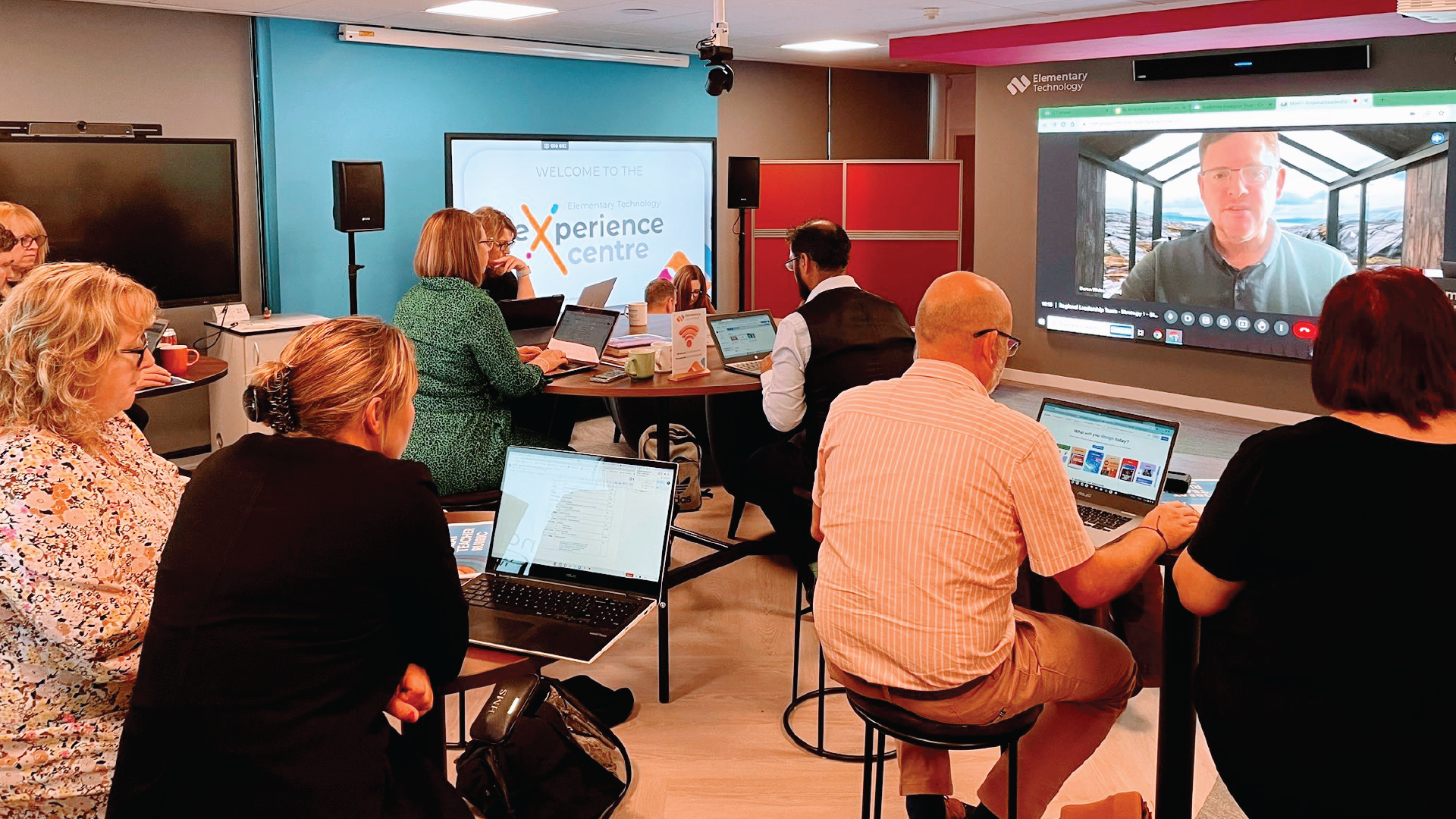 A group of people using Elementary Technology's experience centre to learn about classroom technology.