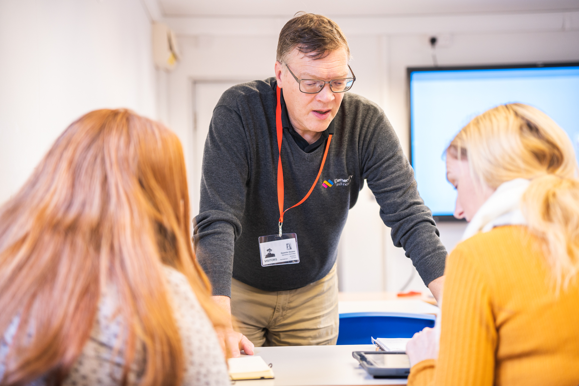 Two teachers learning how to use classroom technology.
