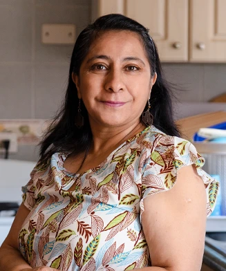 Woman standing in her home kitchen