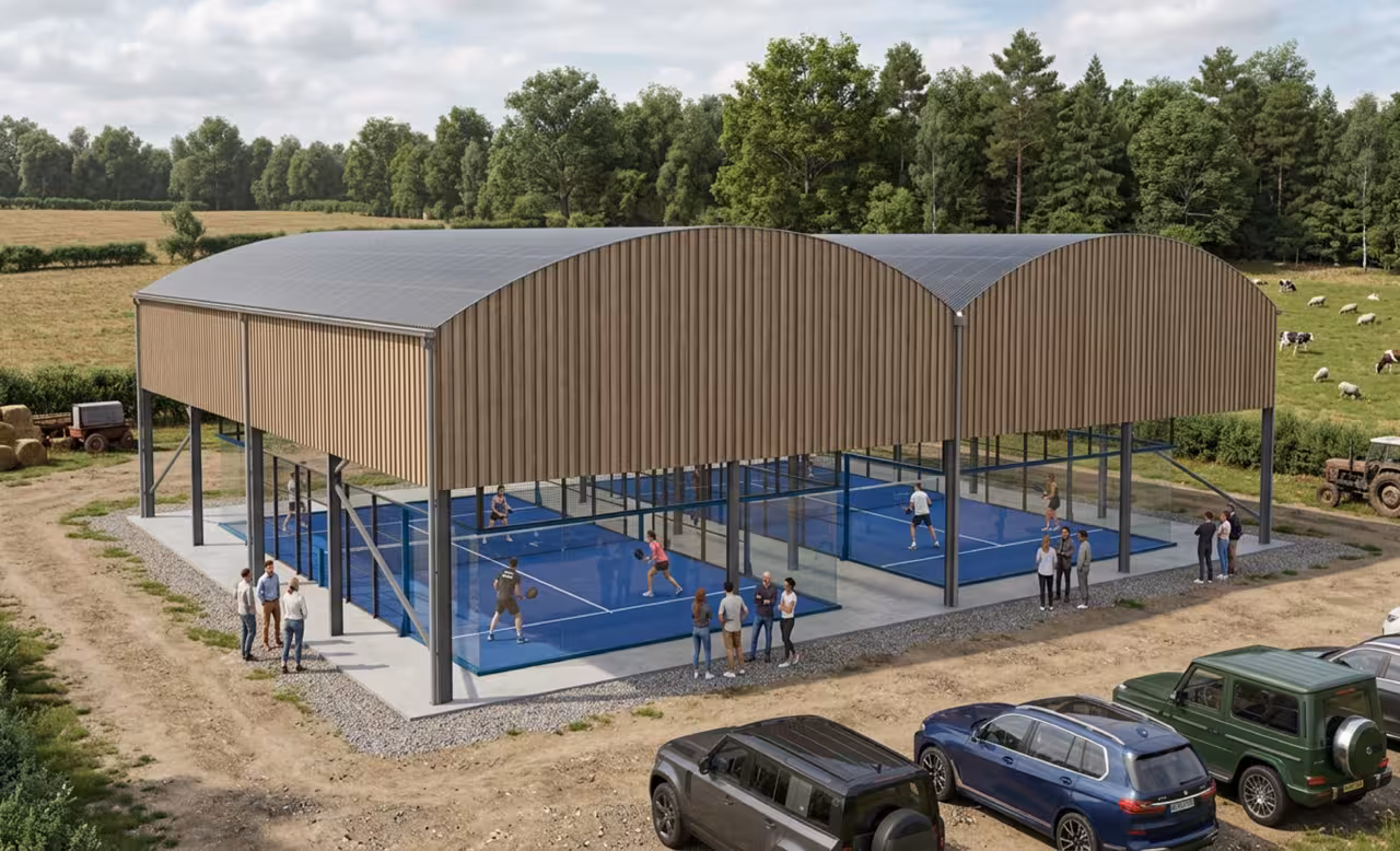 Padel Barn two-court canopy with arched roof and timber cladding in a rural setting