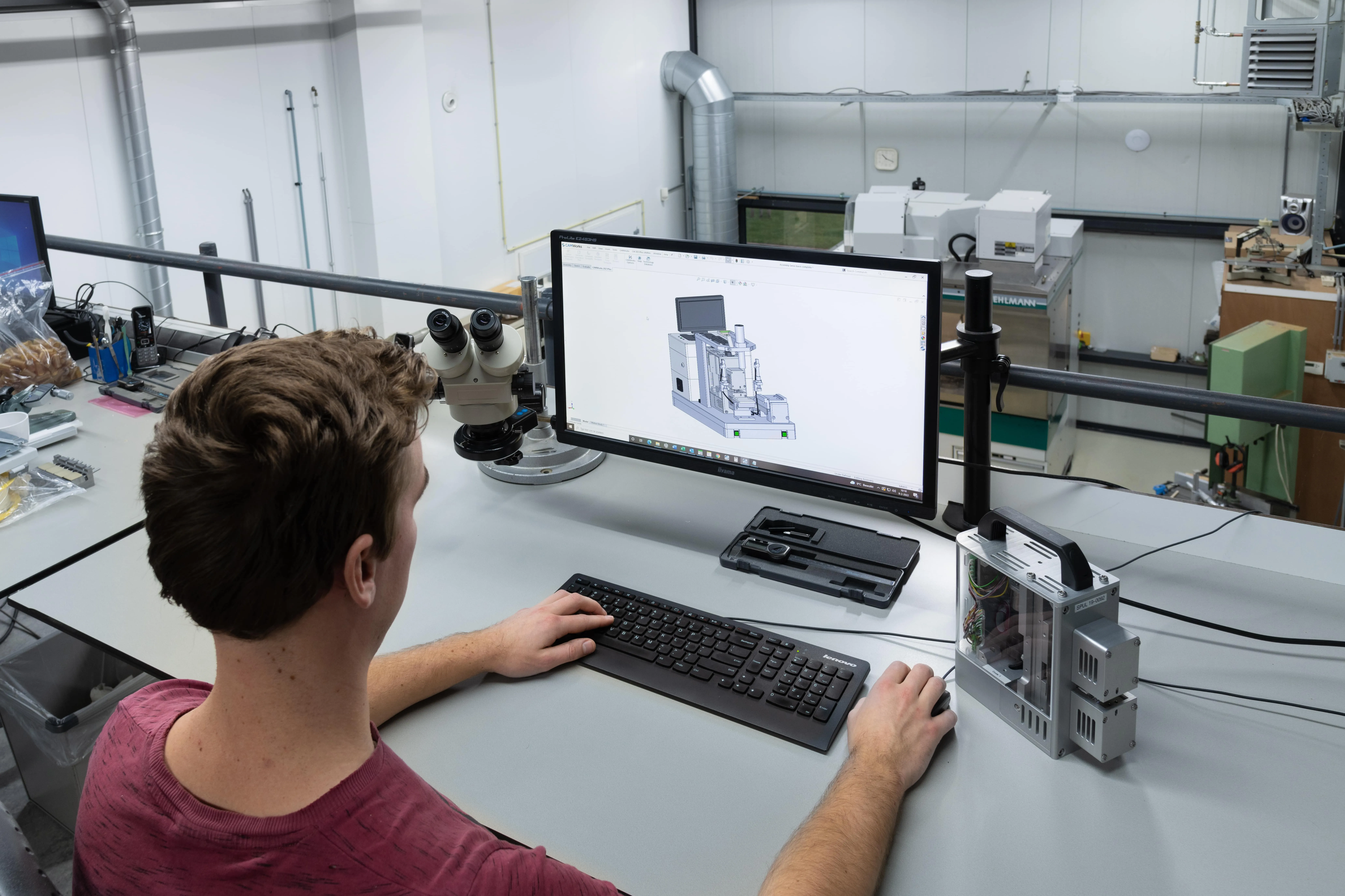 A Millar employee makes adjustments and customizations to the working design of a medical device.