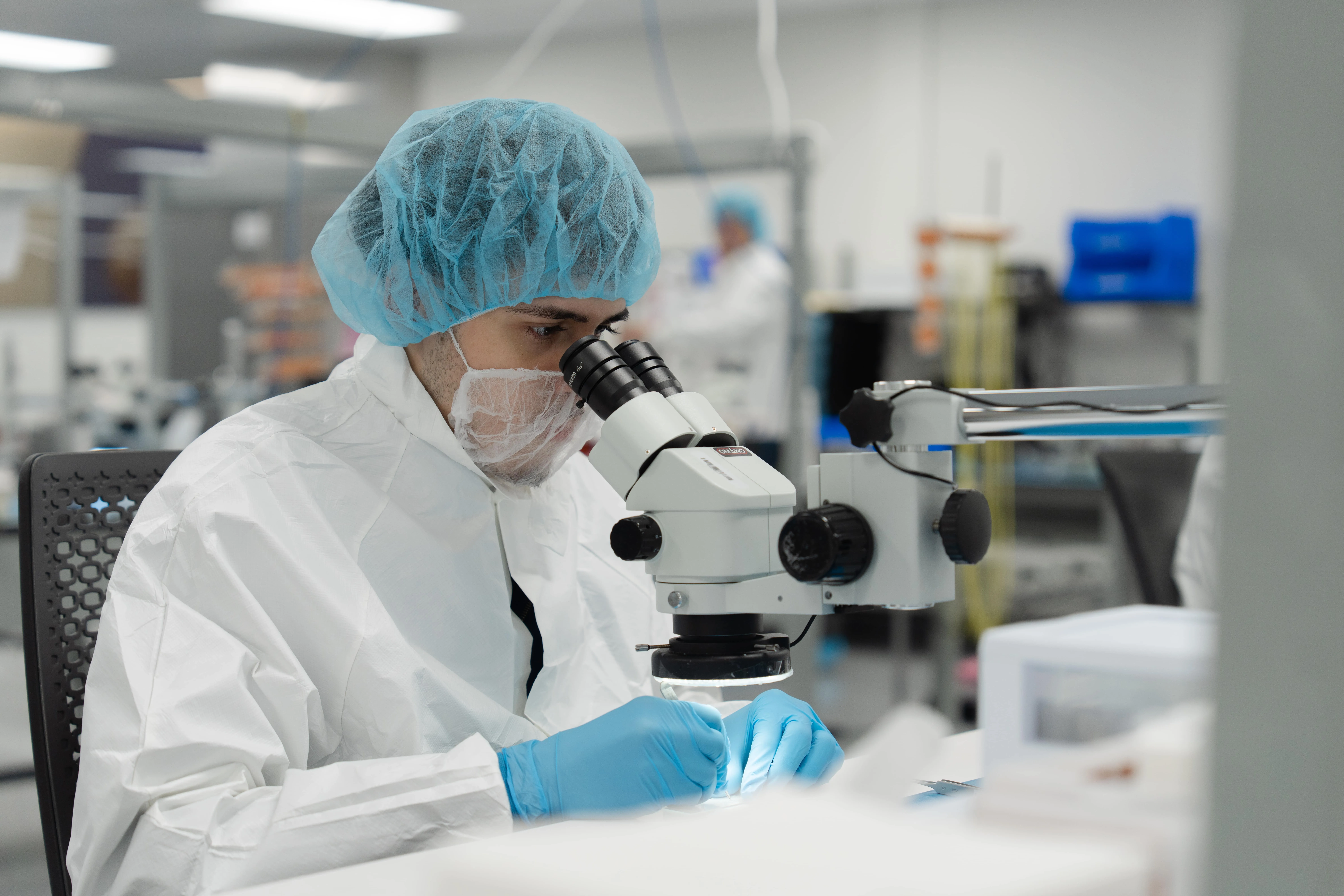 A Millar employee peers through a microscope in Millar’s ISO Class 7 clean room.