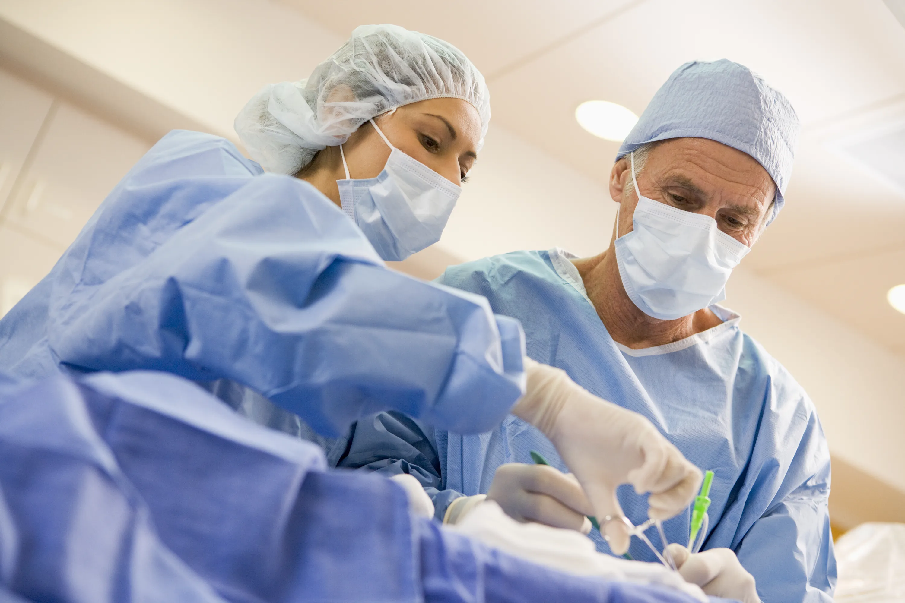 Two medical professionals apply a device that uses a Millar’s temperature sensor during a procedure.