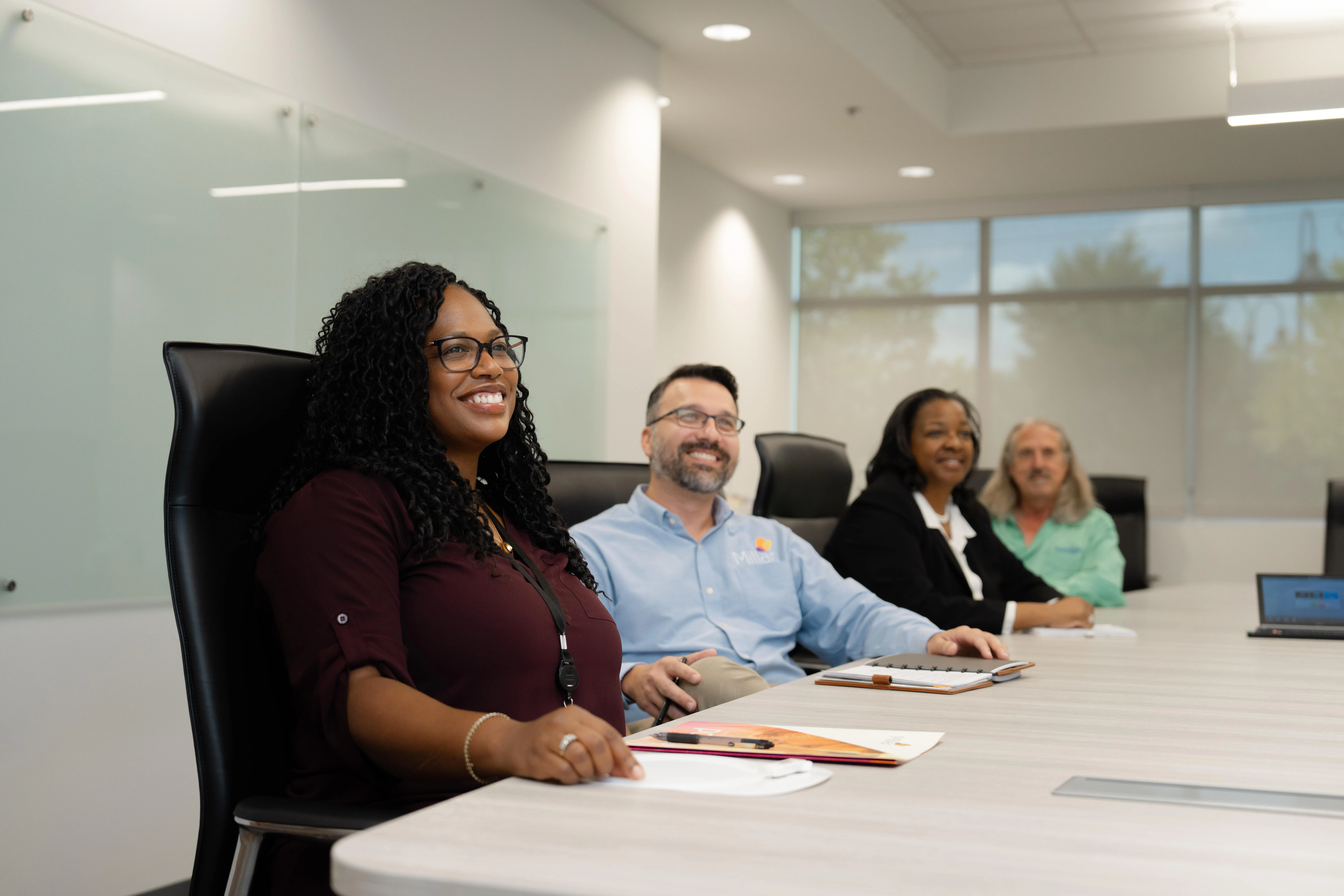 Millar sensor experts smile during a meeting at Millar headquarters.