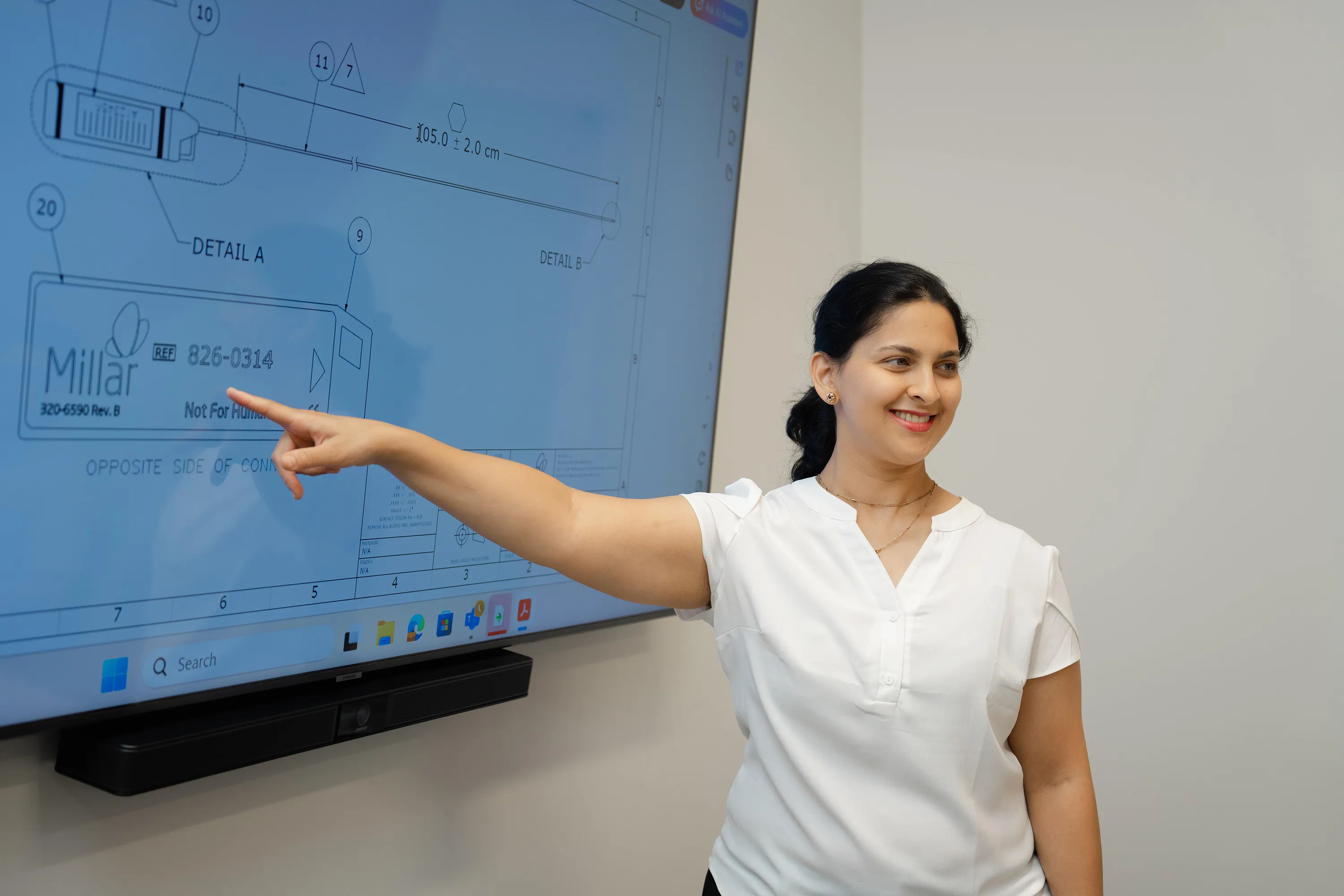 A Millar employee points to a screen showing a graphic rendering of a Millar pressure sensor.
