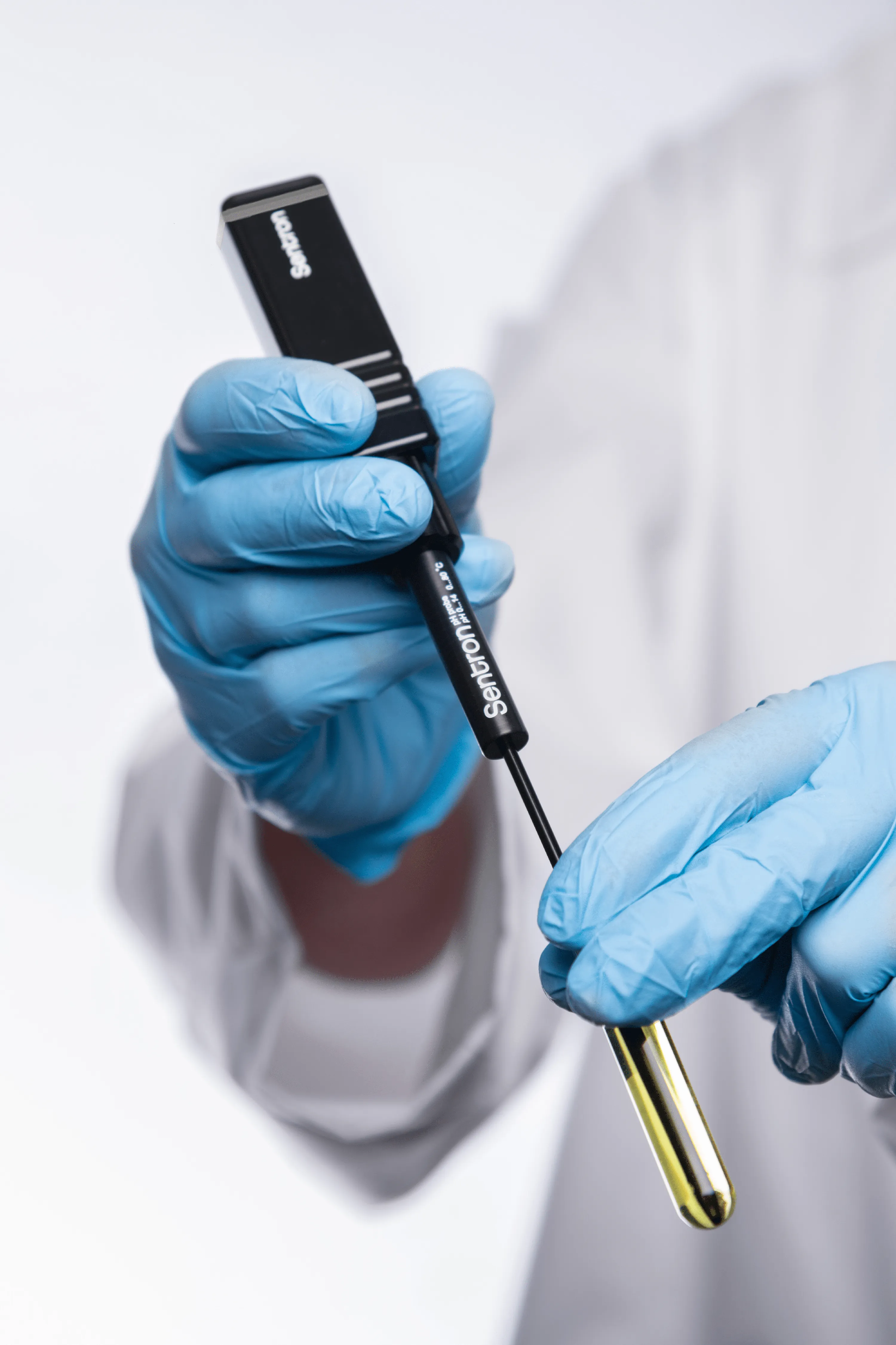 A lab worker uses a Sentron pH probe. 