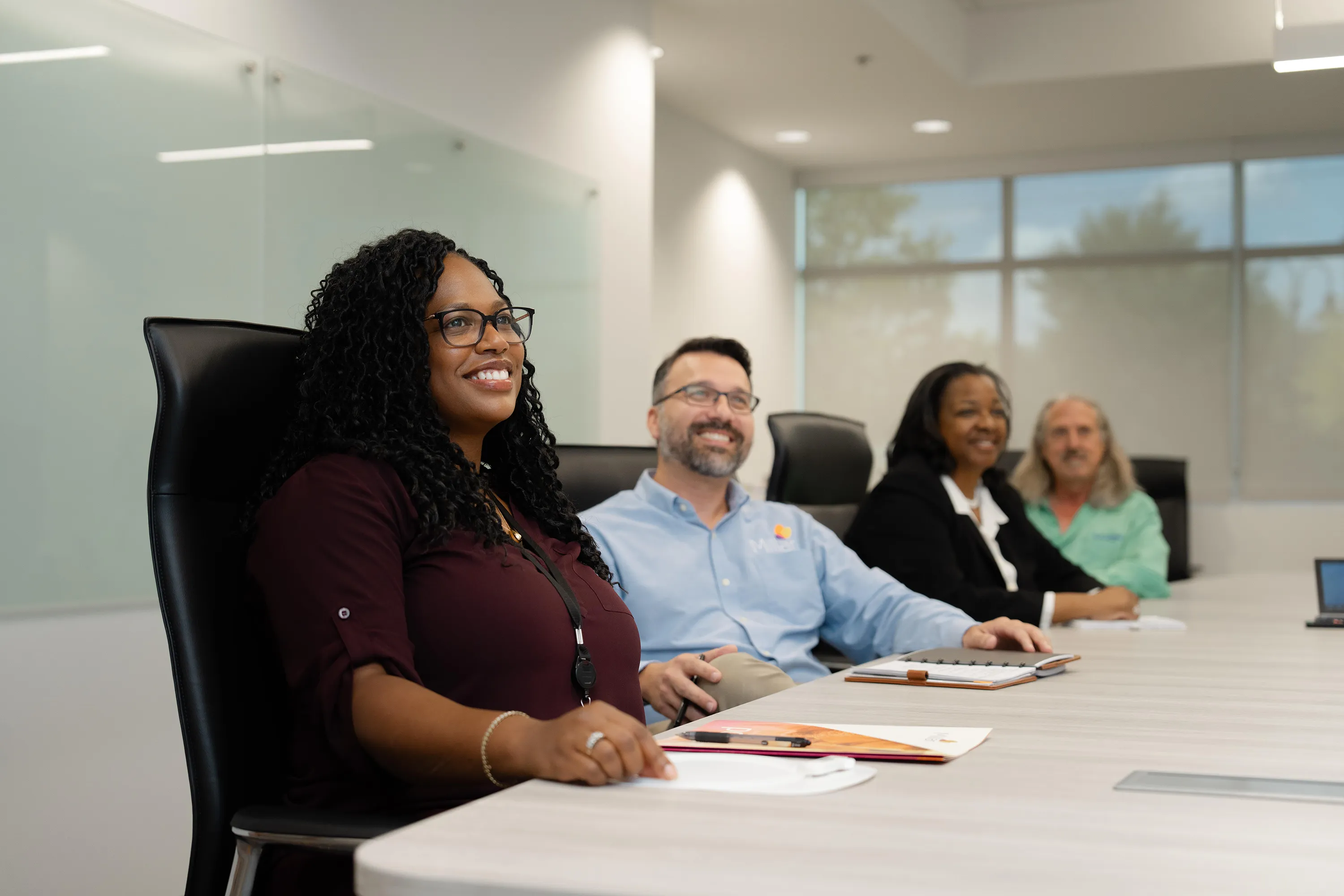 Millar sensor experts smile during a meeting at Millar headquarters.