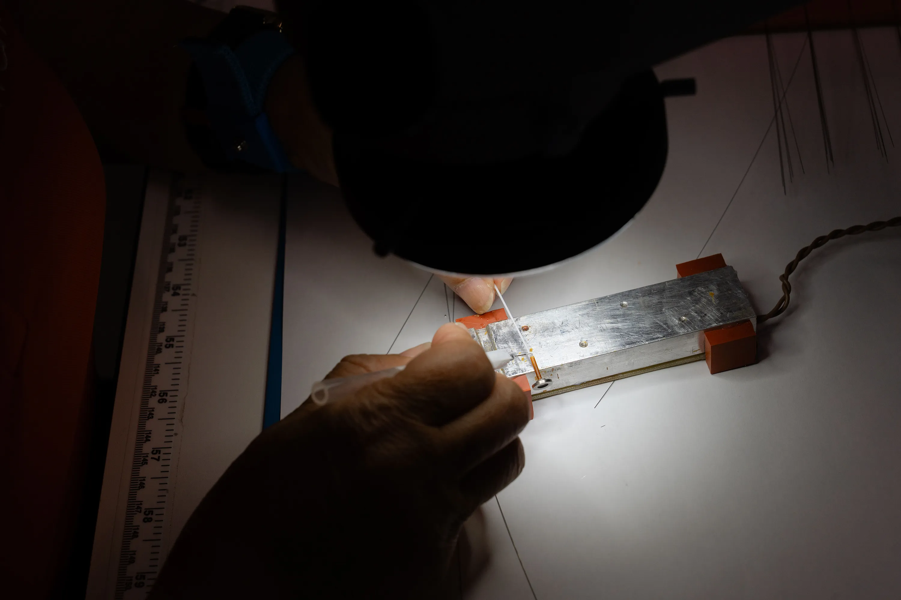 A Millar sensor expert works on a precision sensing device.