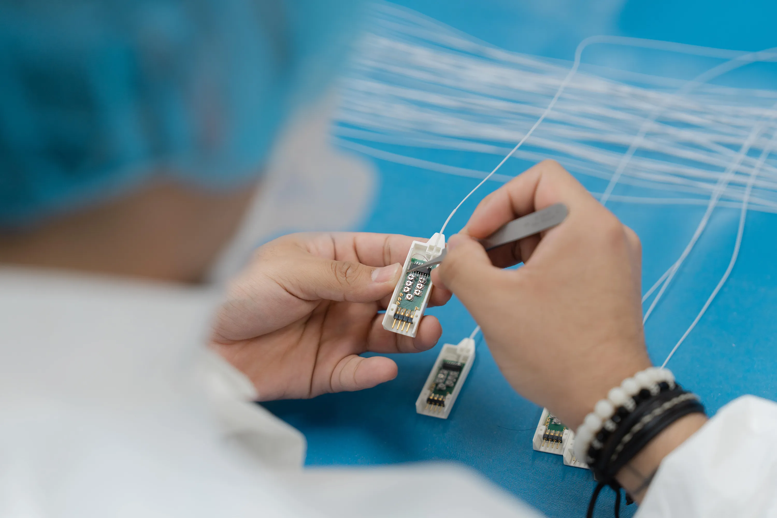 A Millar employee carefully works on a Mikro-Cath pressure catheter.
