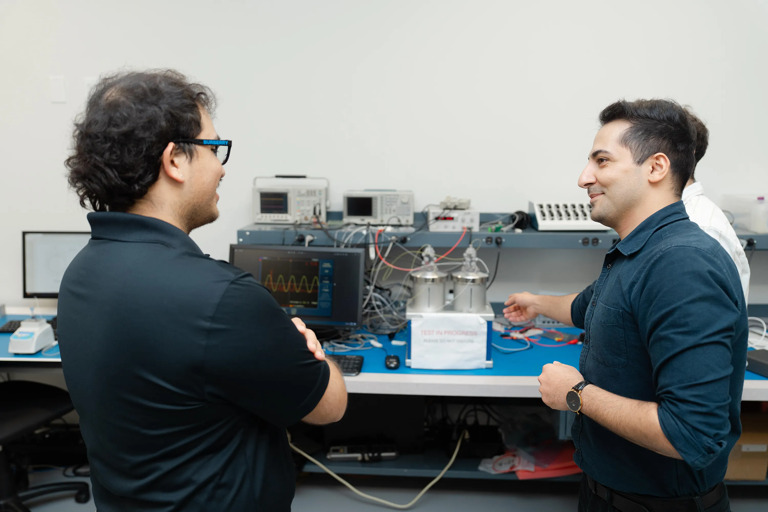 Members of Millar’s Industrial Sales Team examine a laboratory device at Millar’s headquarters in Pearland, Texas.