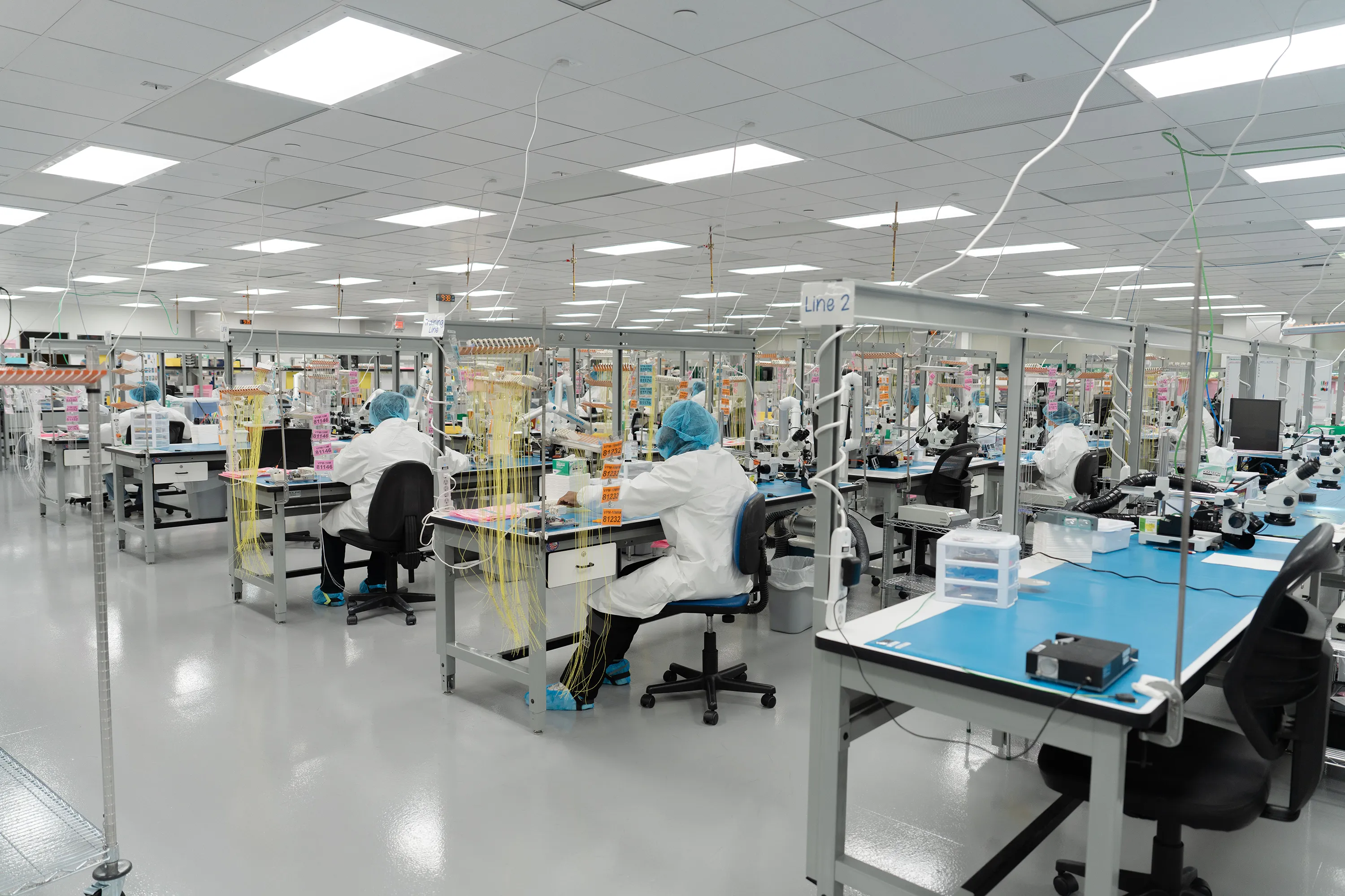 Millar employees working at several rows of lab benches in Millar’s ISO Class 7 clean room.