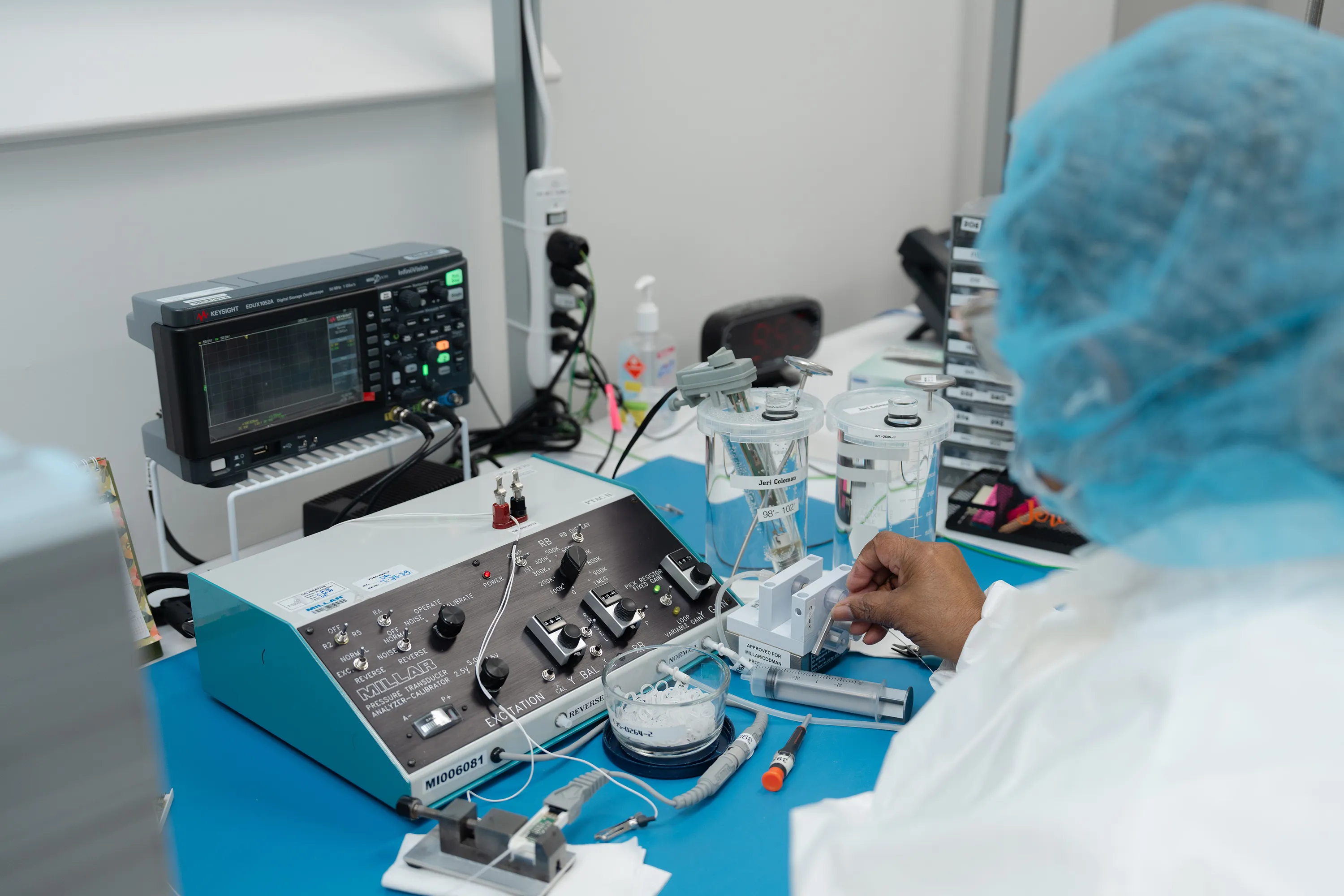 A lab technician works closlely on design adjustments for a medical device with an integrated Millar sensor.