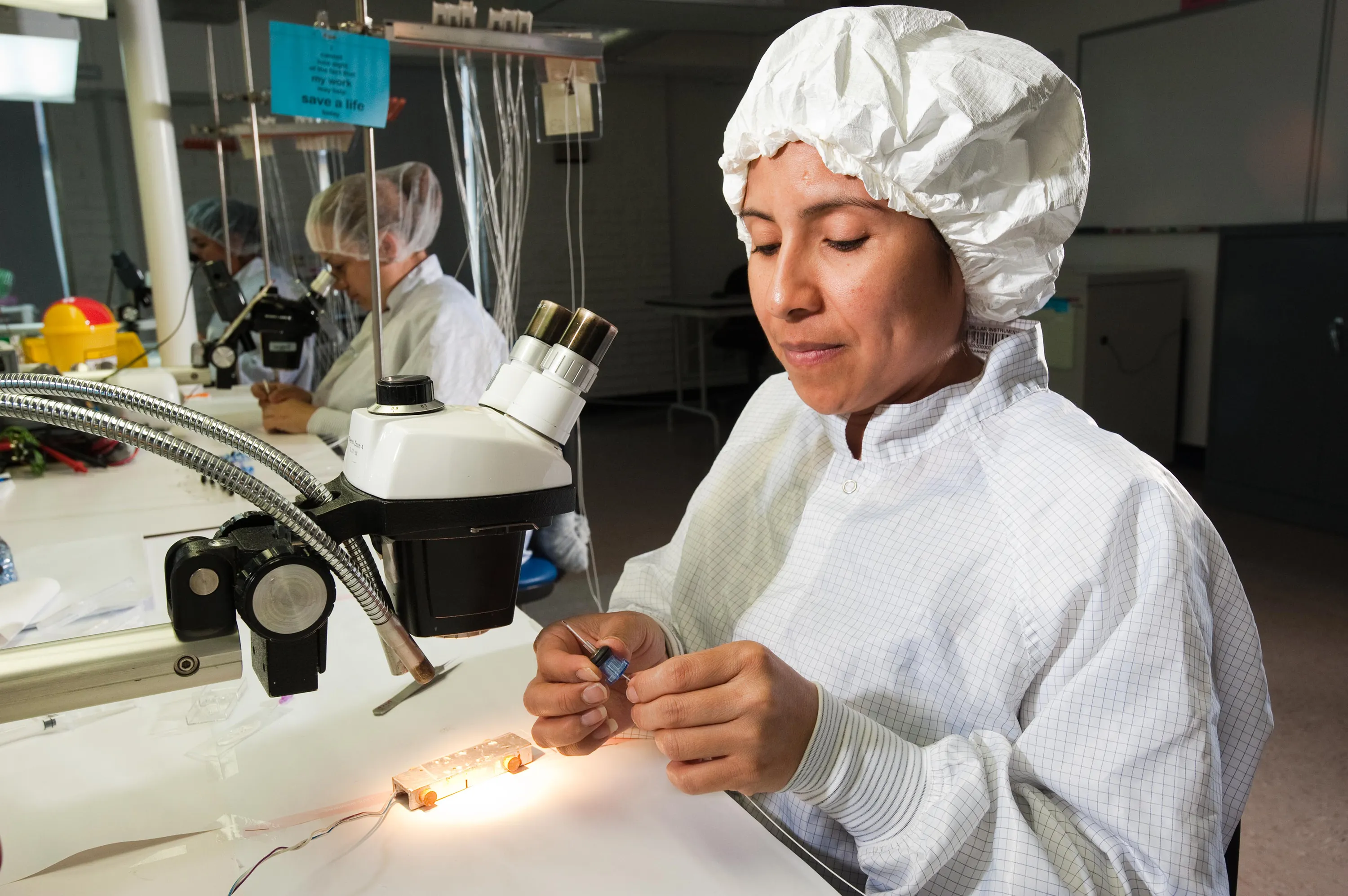 A Millar employee works diligently on an industrial OEM device.