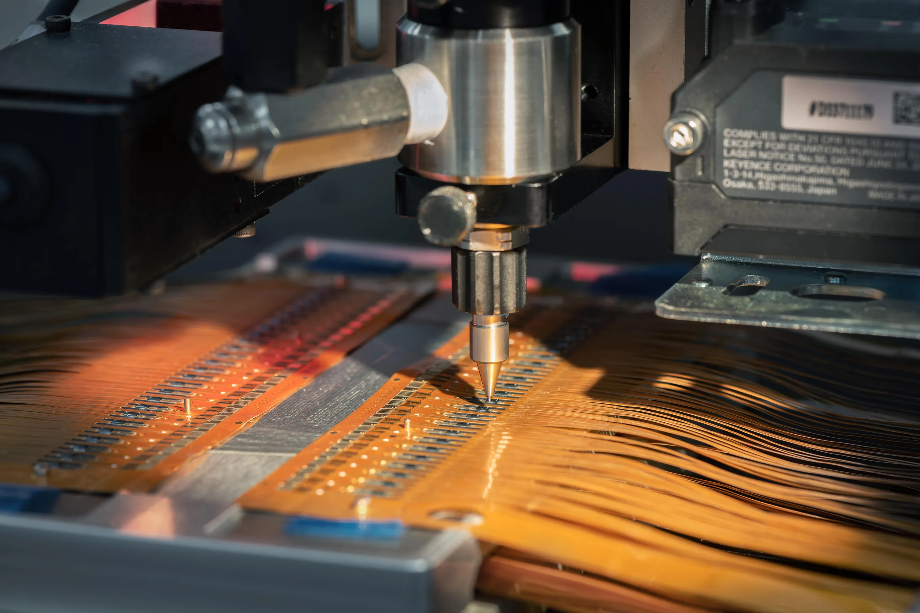 A machine manufactures pressure sensors on a flex board. 