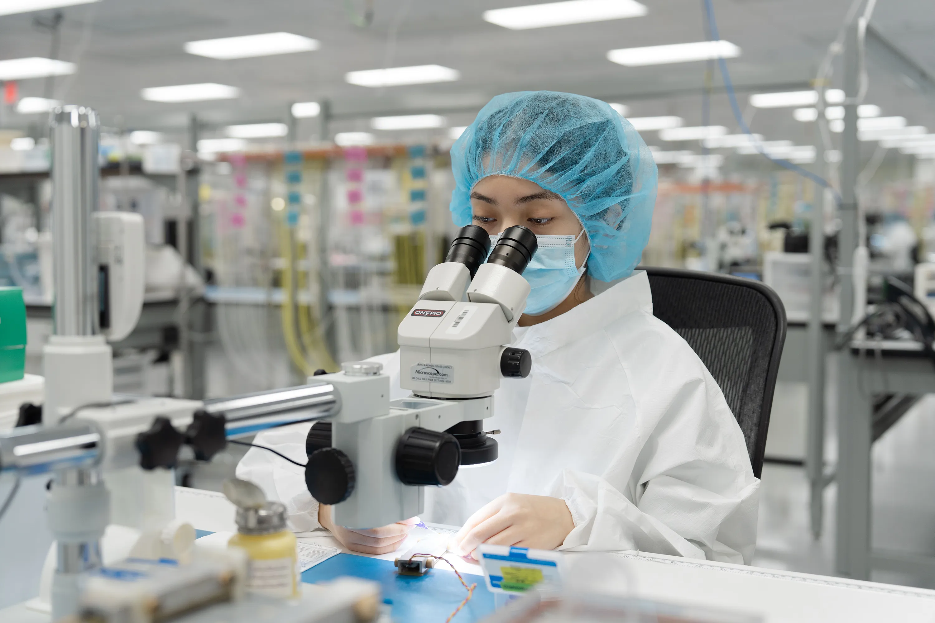 A lab technician looks through a microscope in Millar’s ISO Class 7 clean room.