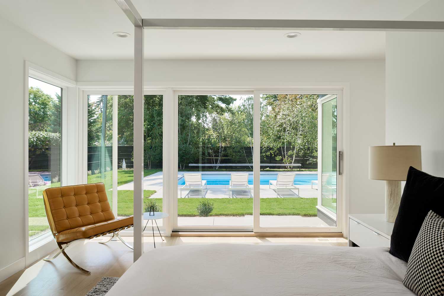 Bedroom with large doors going out to pool