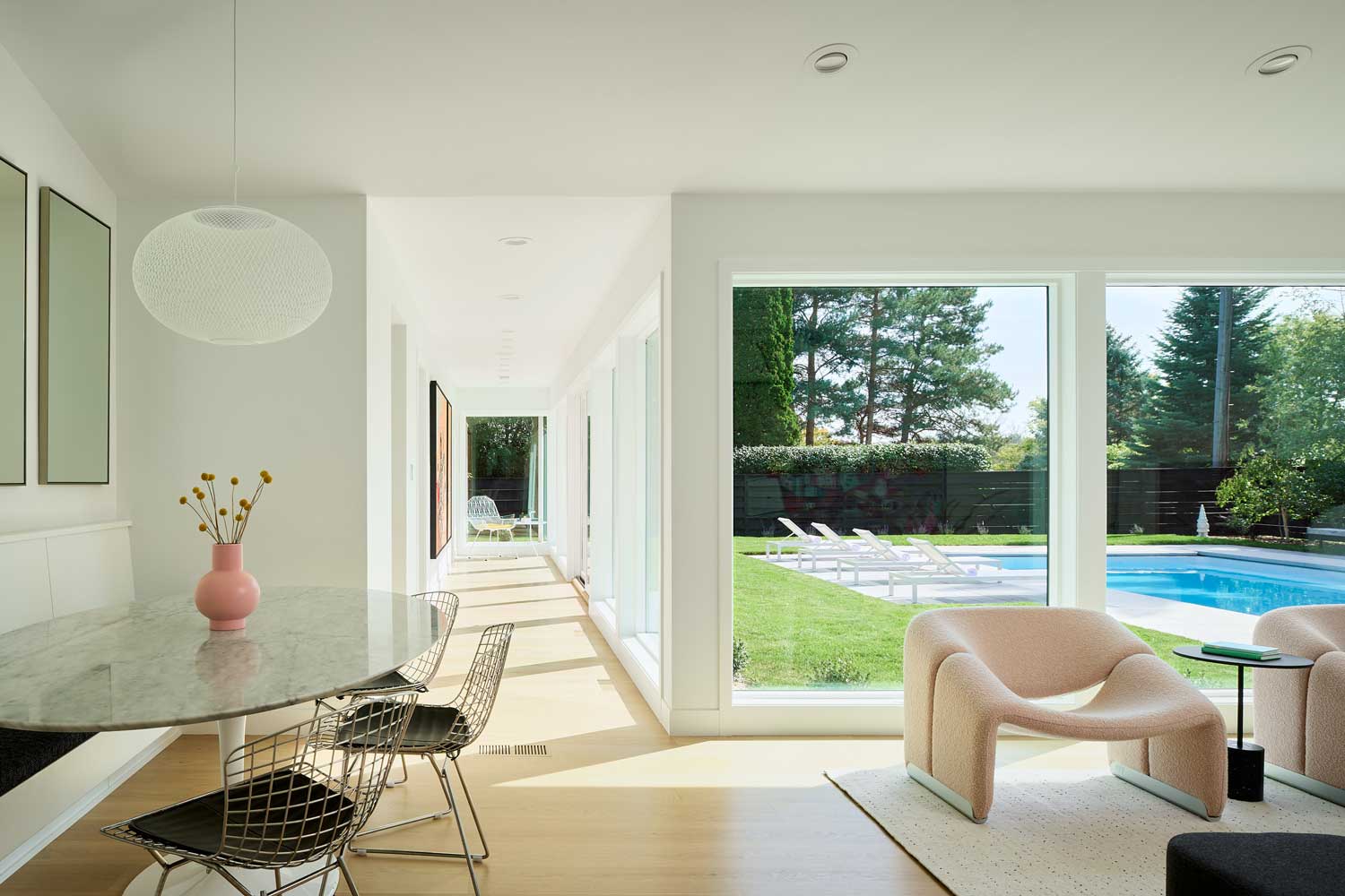 Hallway of windows leading out to pool