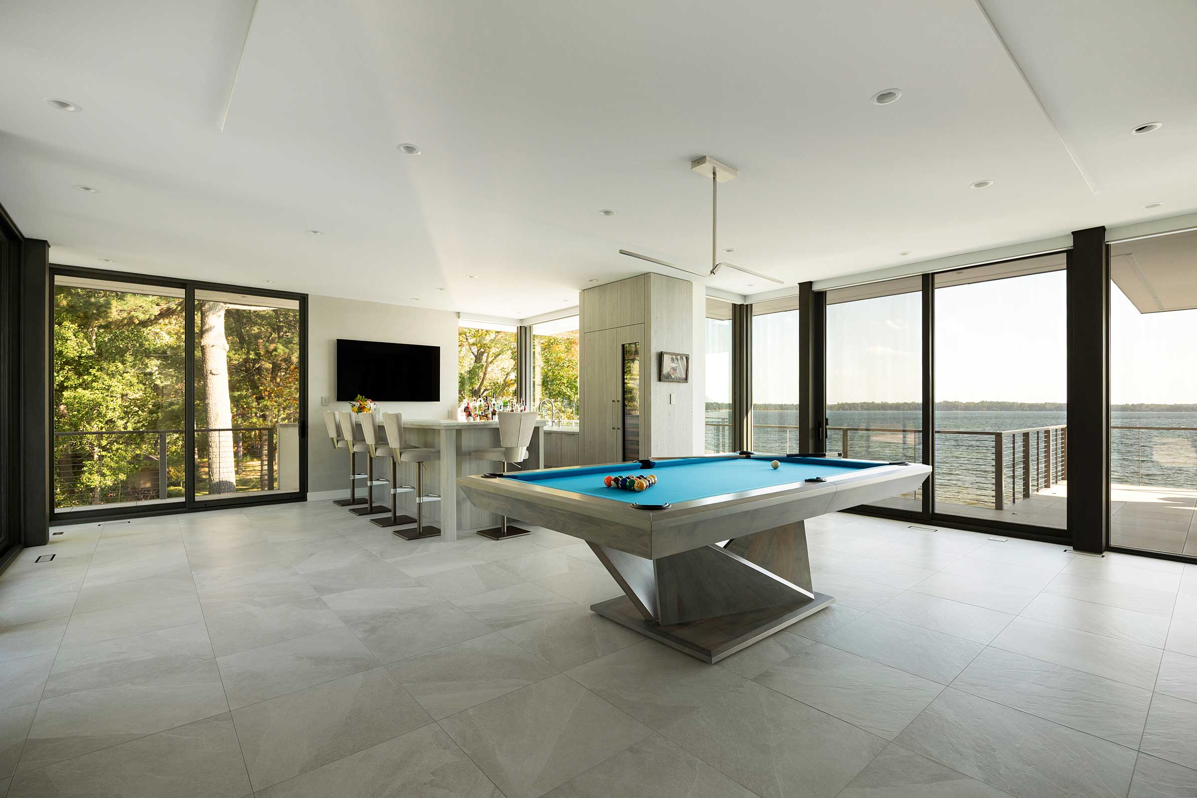 Modern recreation room with pool table and bar