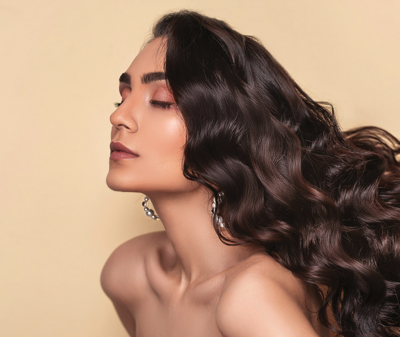 Woman with shiny hair against yellow background