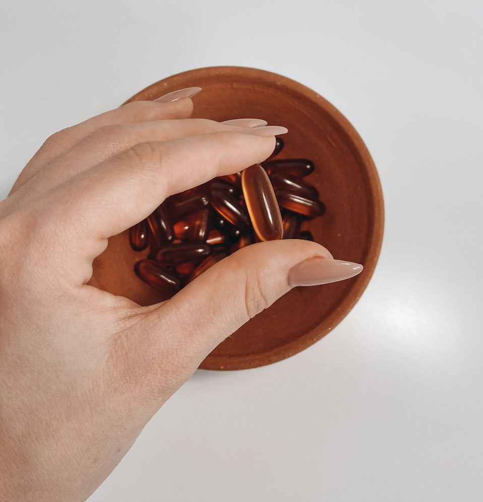 Hand holding a supplement 