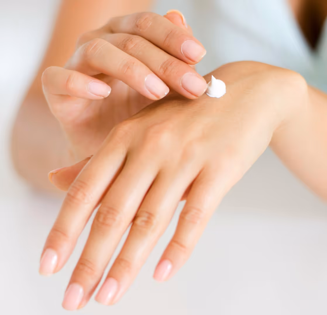 women applying cream on hands