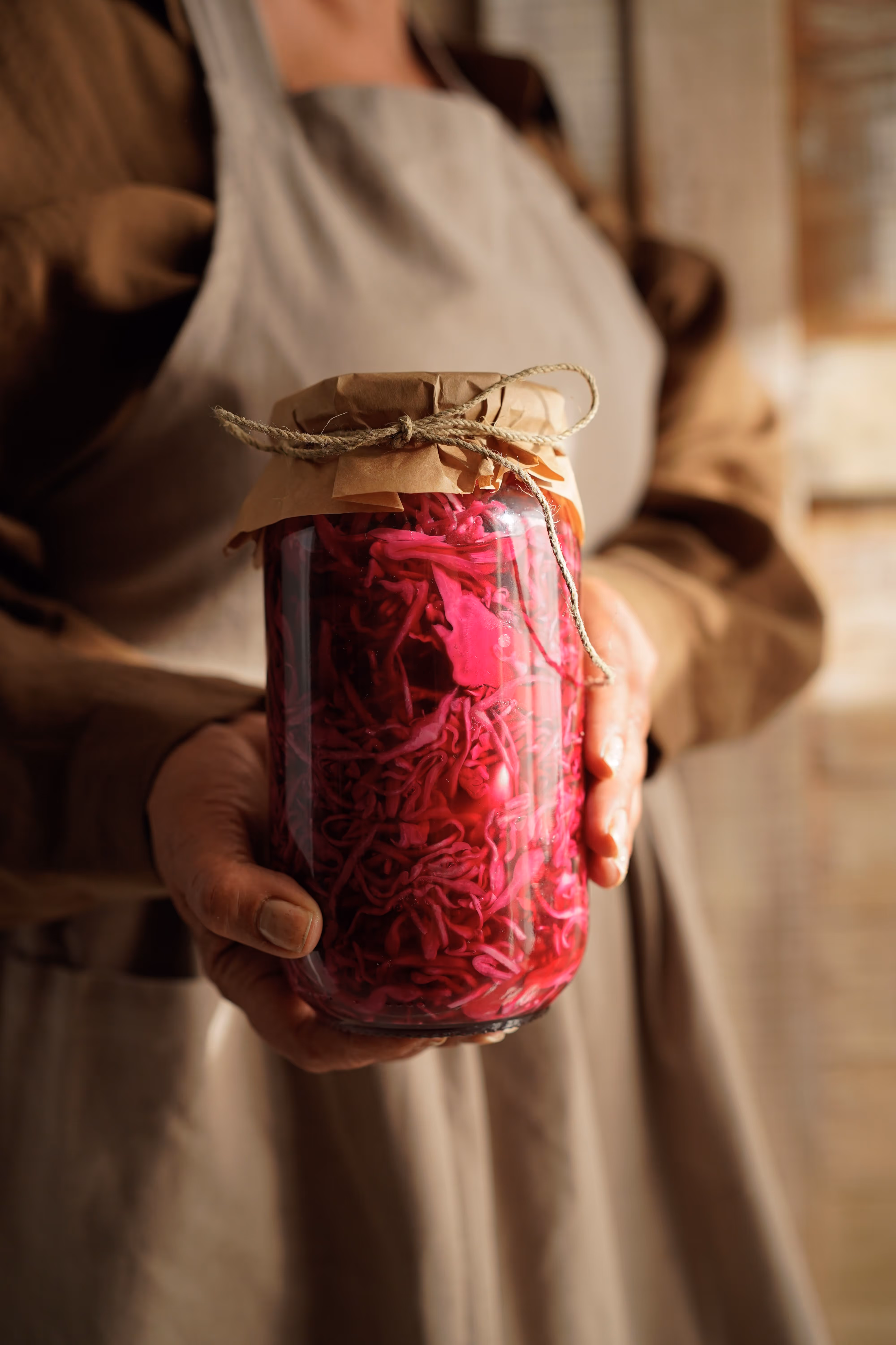 woman carrying pickled onions jar