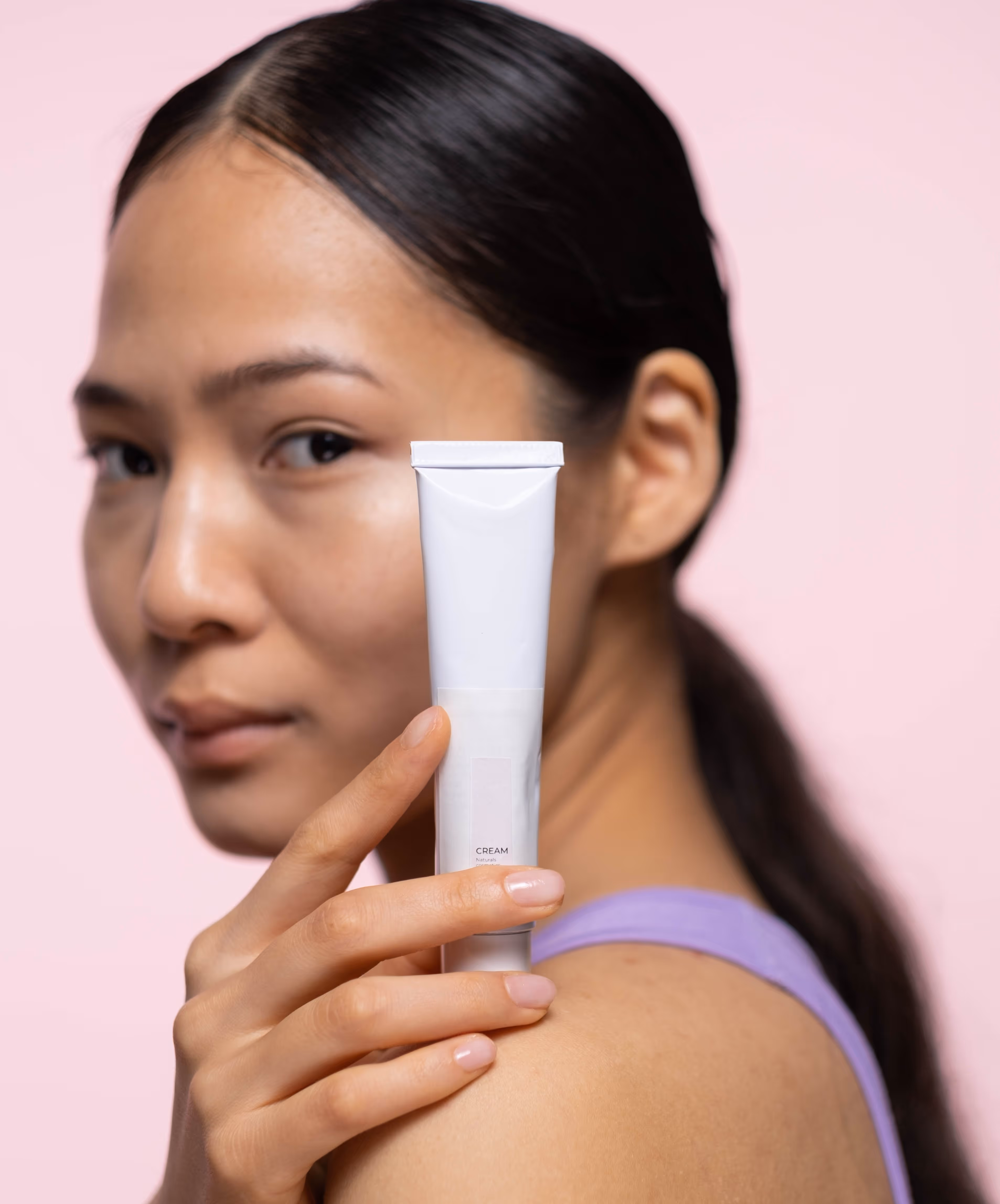 woman holding tube of cream