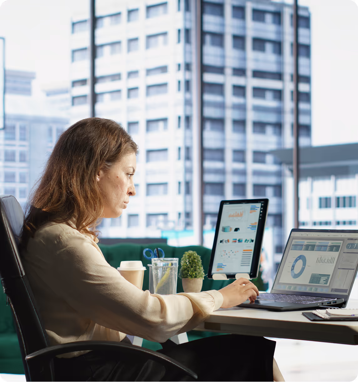 Professional working on data analytics with laptops in modern office