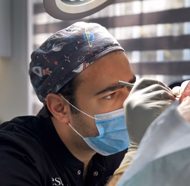 Dr. Vanand performing hair transplantation procedure with a nano needle.