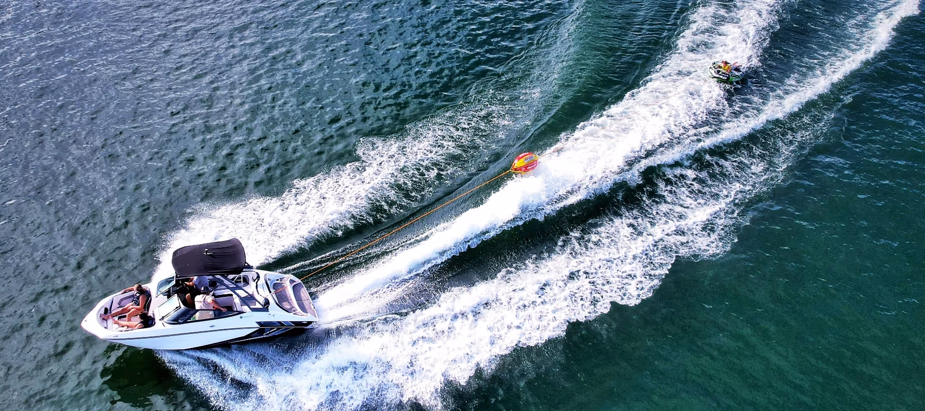 Boat on water pulling tube