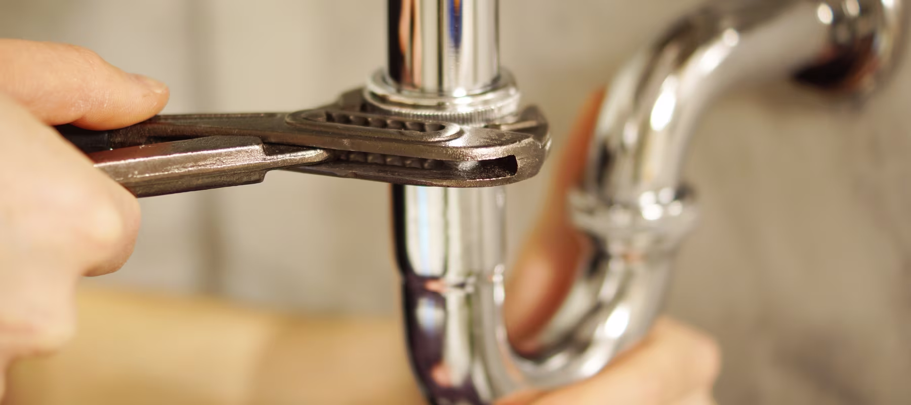 plumber using pipe wrench