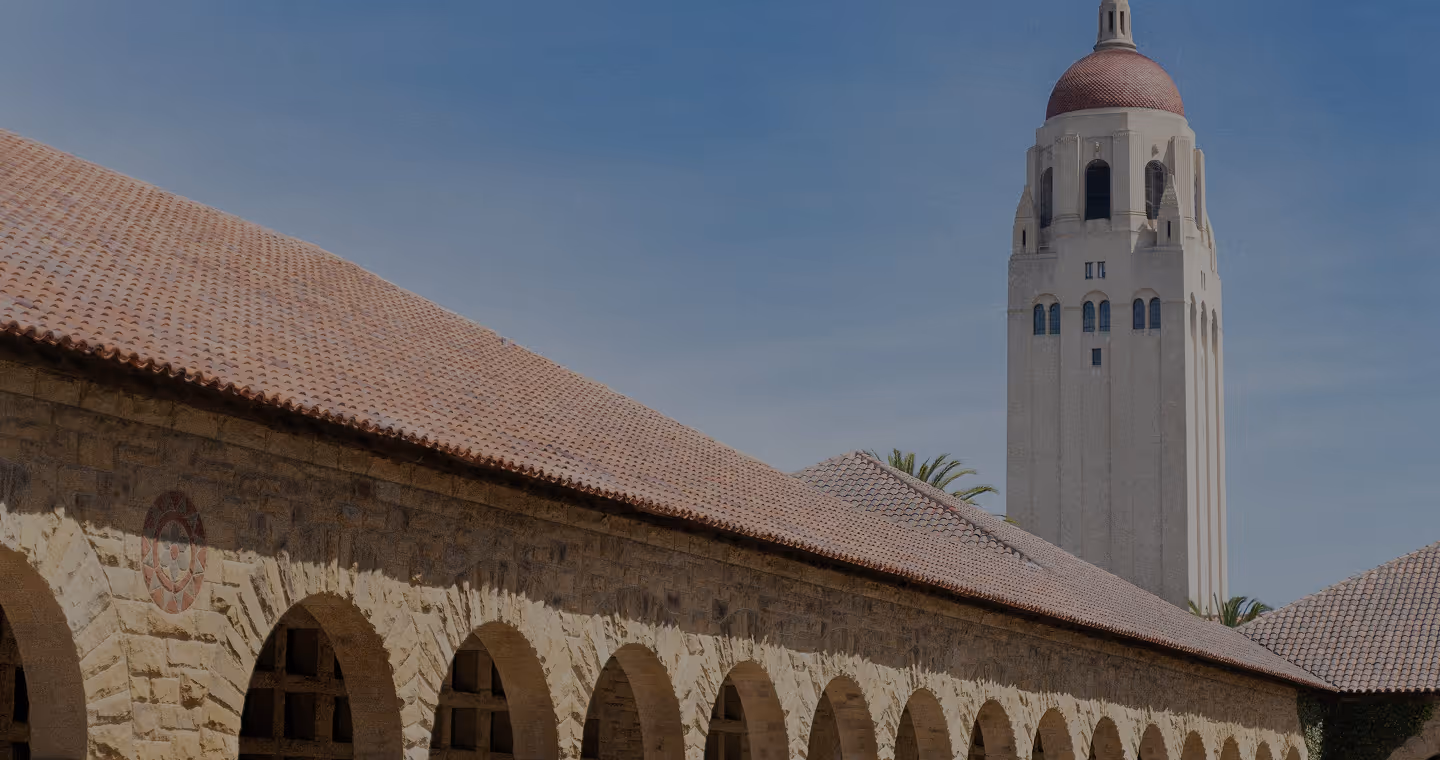 A picture of two old buildings, likely Stanford.