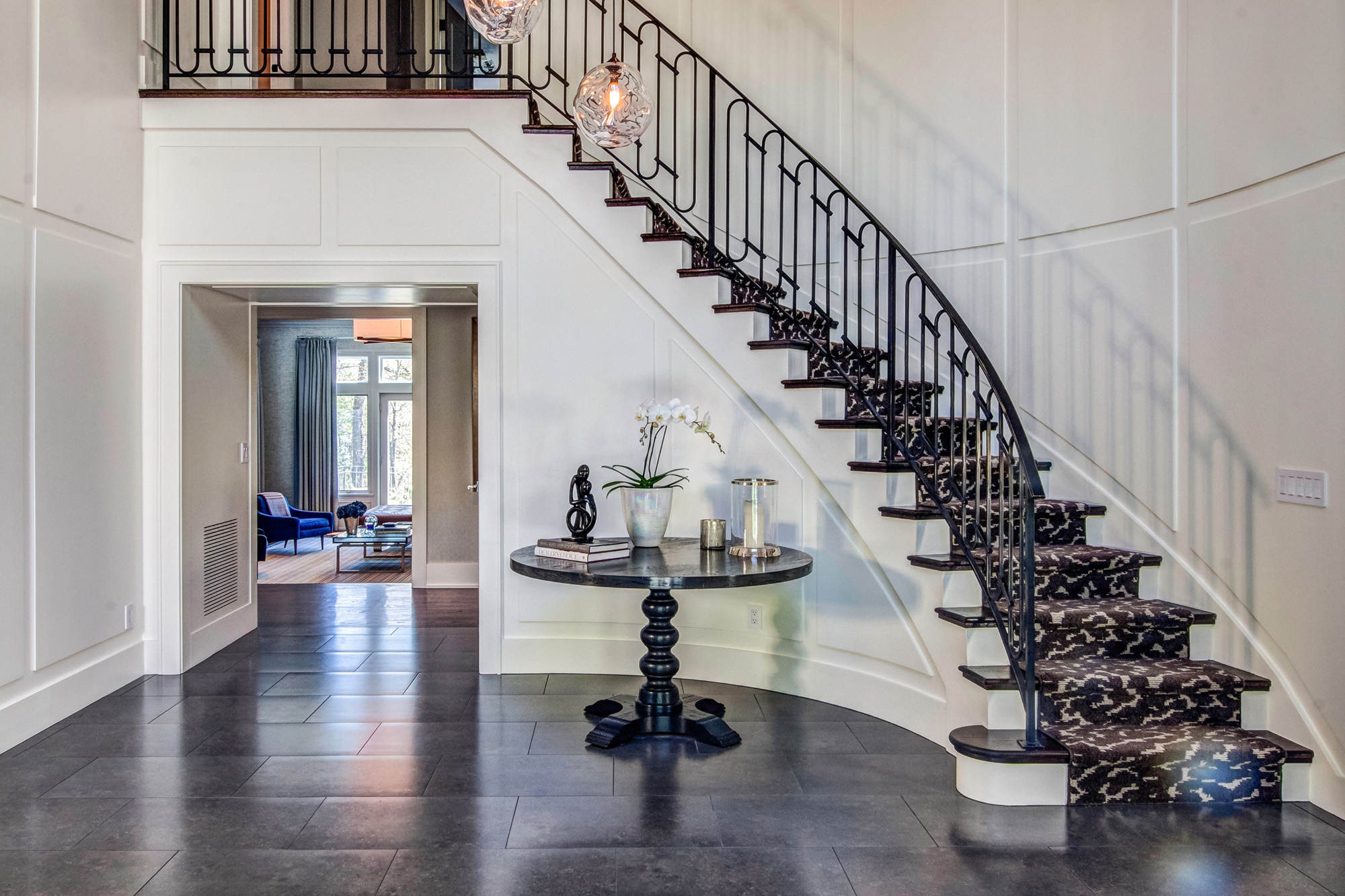 Entryway with round table and staircase.