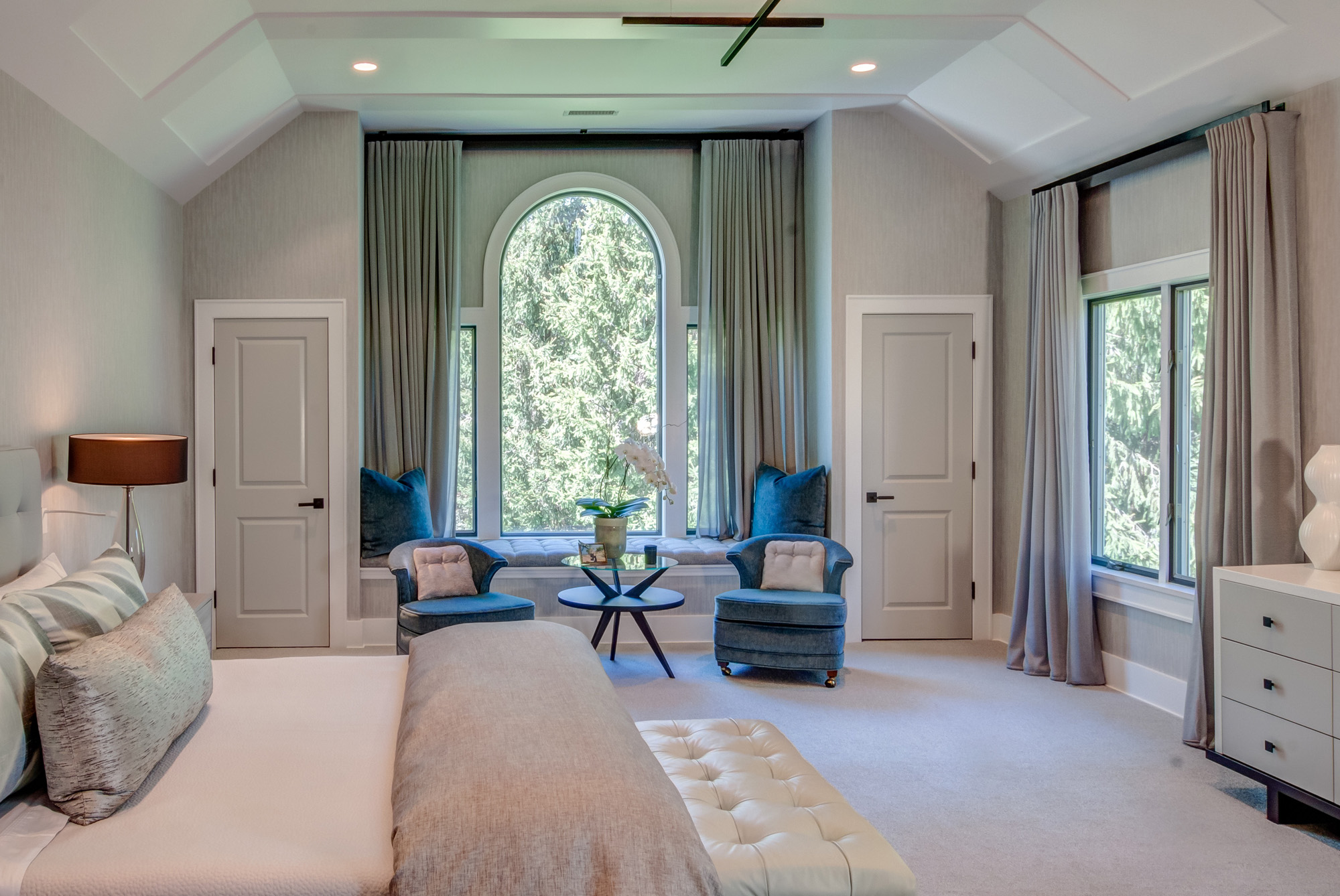 Spacious bedroom with vaulted ceiling and sitting area.