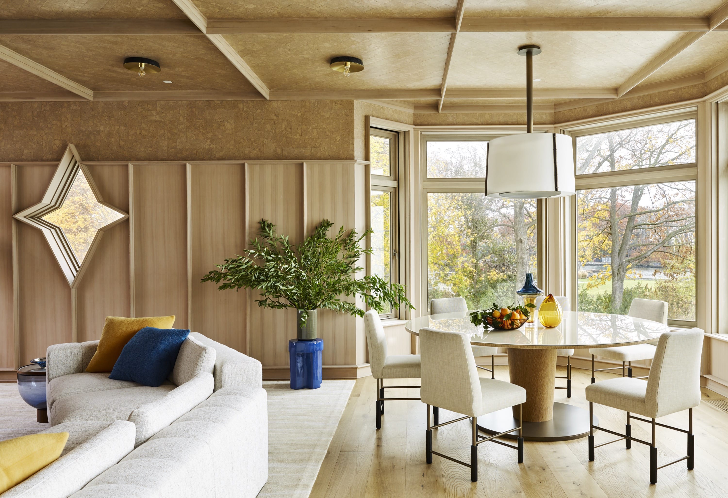 Open living space with sectional sofa and wood accents.