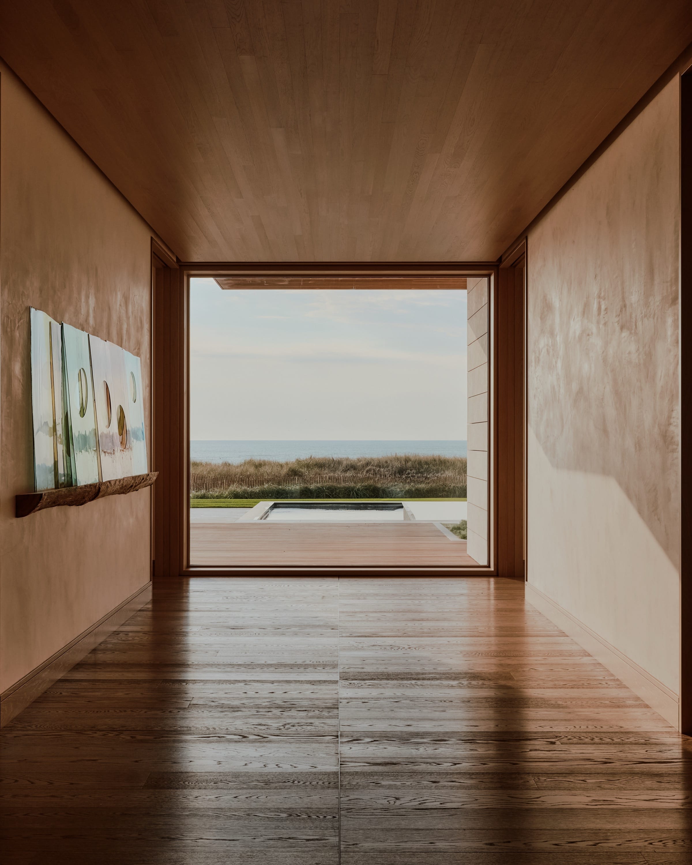Hallway with framed ocean view at the end.