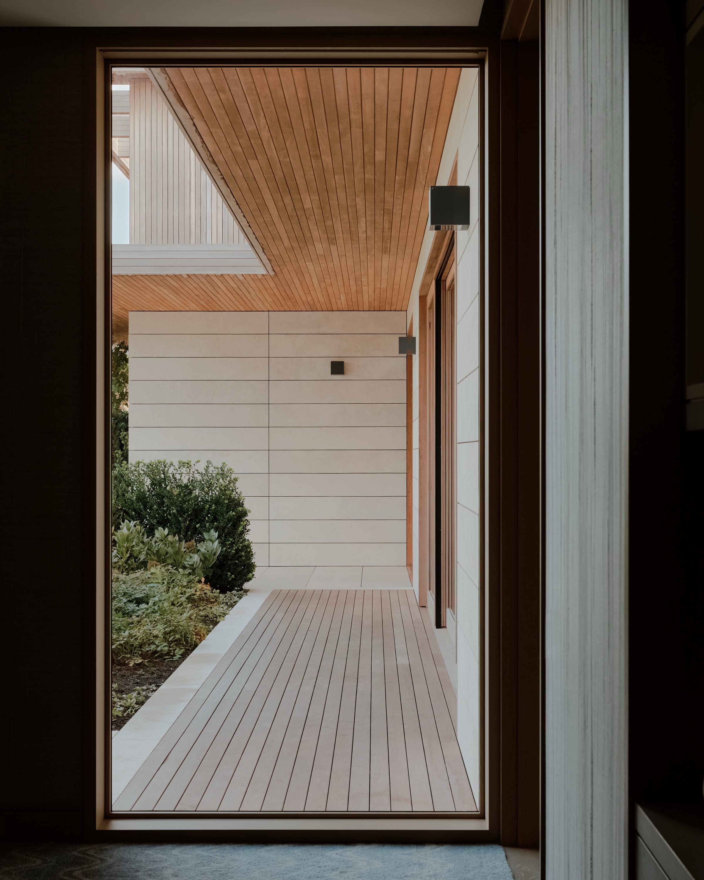 Framed view of terrace with wood and ocean backdrop.