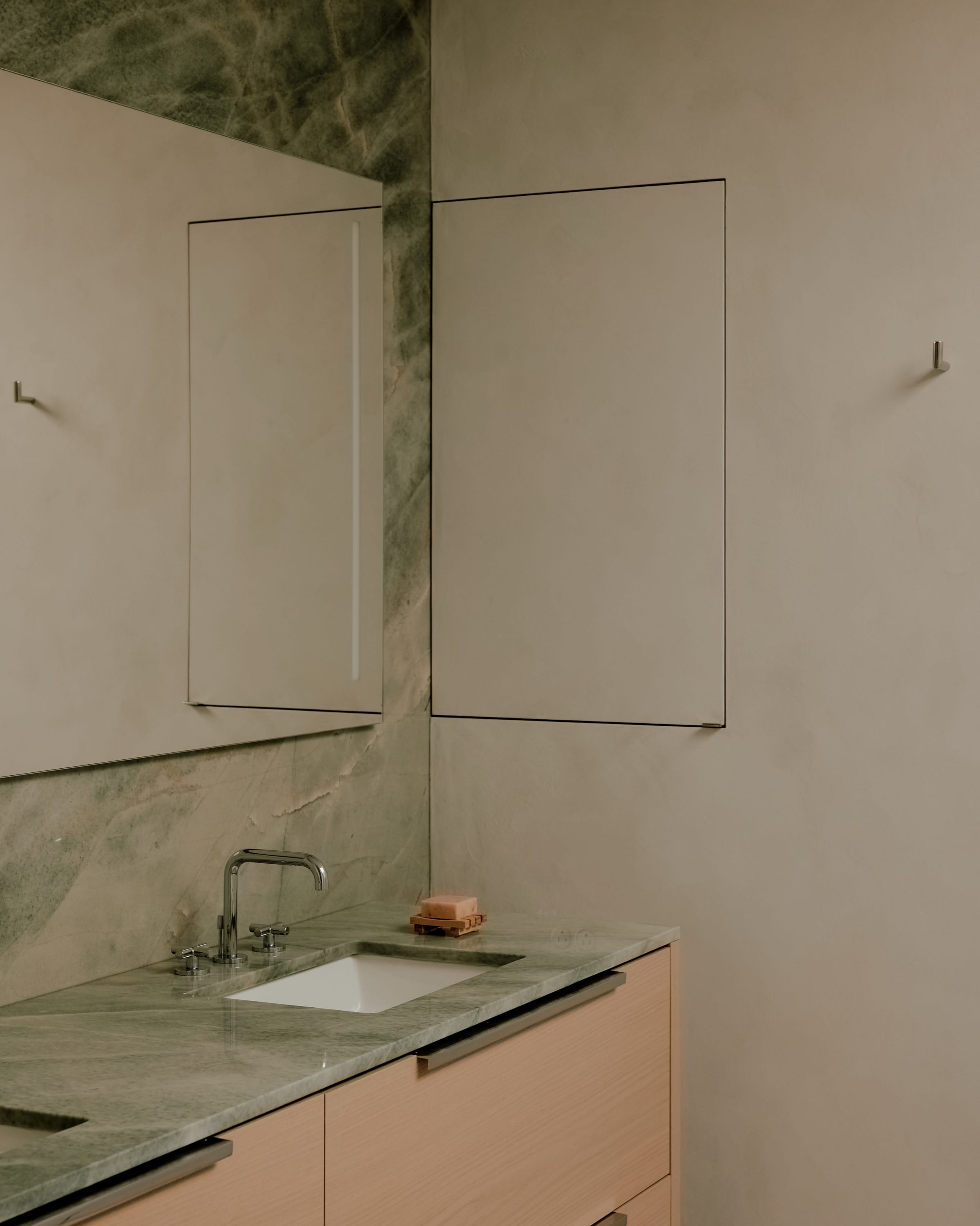 Bathroom with marble walls and modern sink.