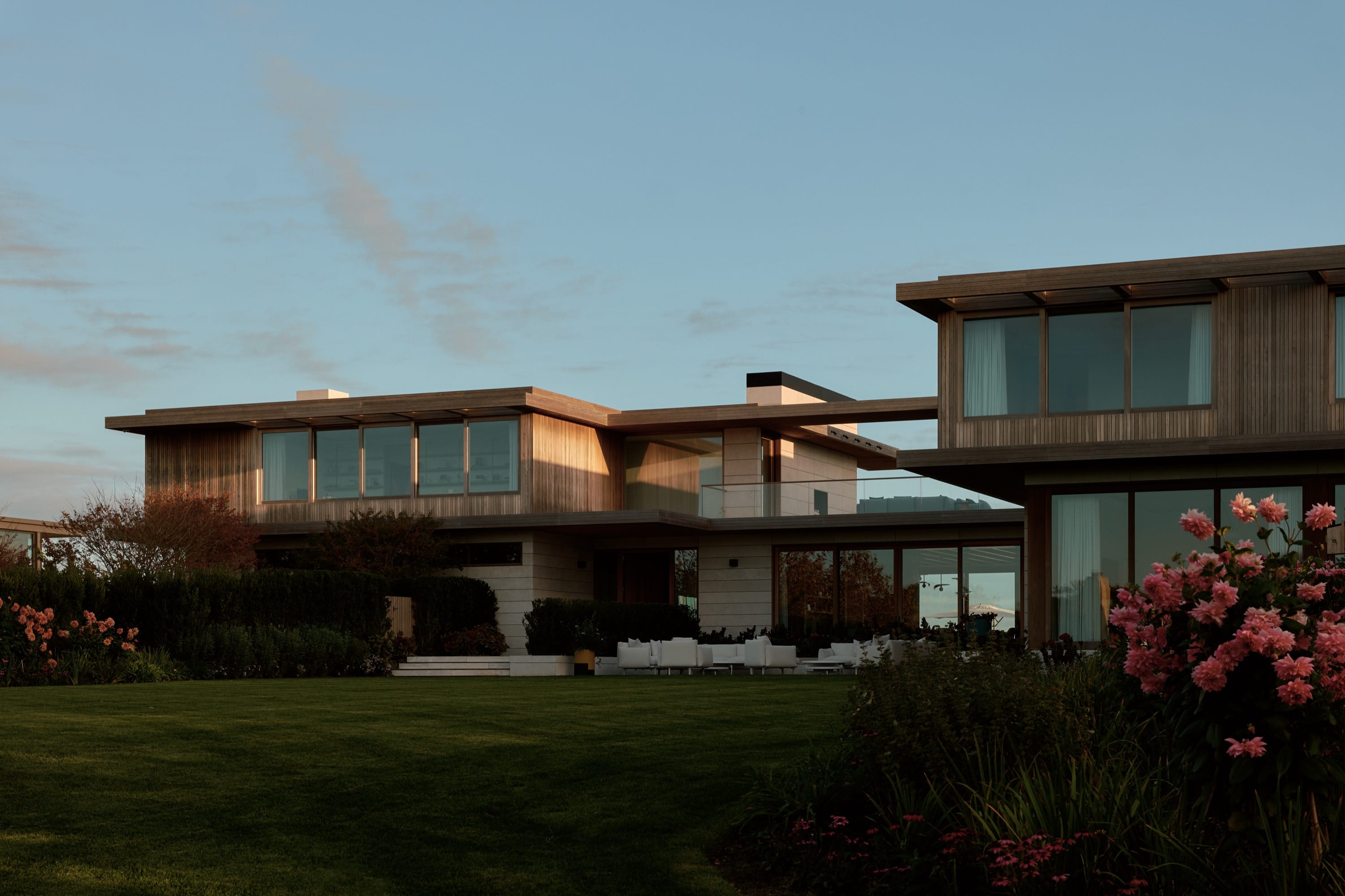 Exterior view of modern home with large lawn.