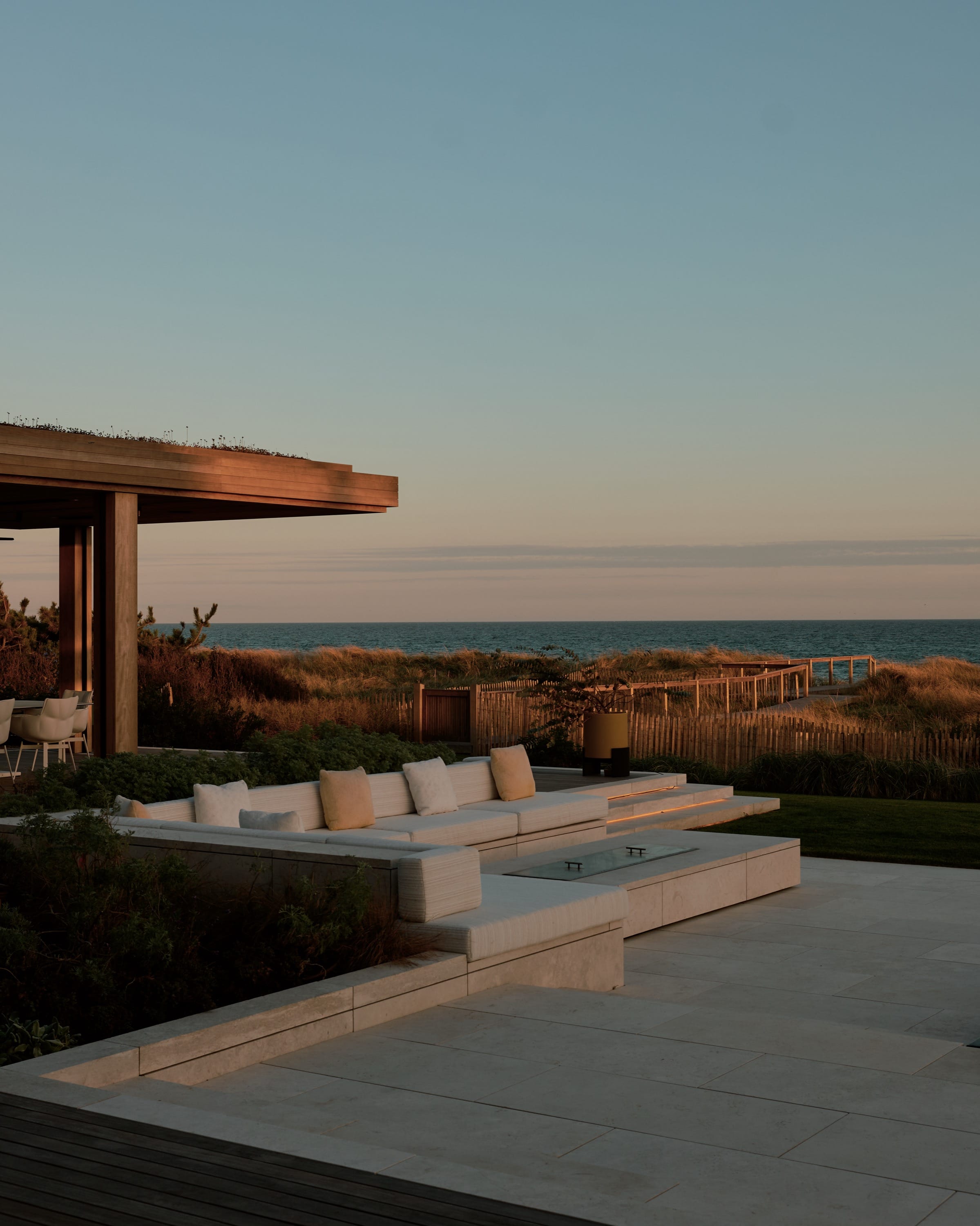 Patio with ocean view and stone flooring.