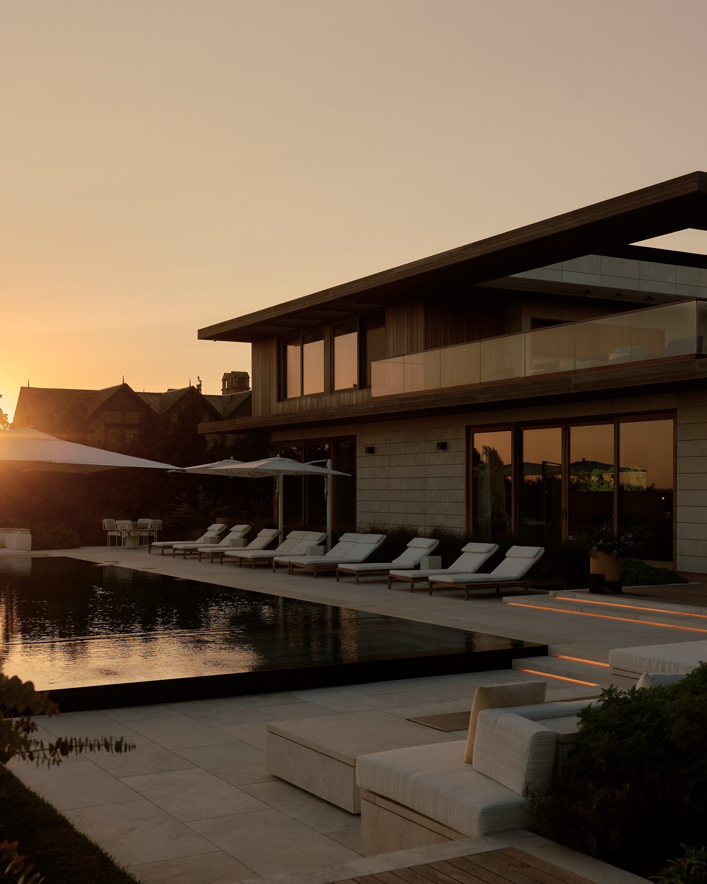 Backyard with pool, lounge chairs, and ocean view.